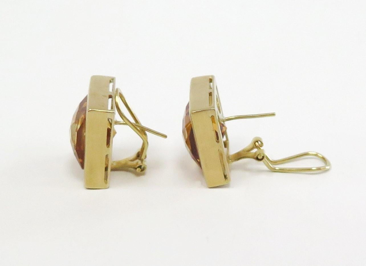 These classic square Citrine earrings are elegant and tasteful. The Citrine stones are a rich orange color and the checkerboard cut creates sparkle. 

The 18 Karat yellow gold omega back earrings measure approx. 3/4