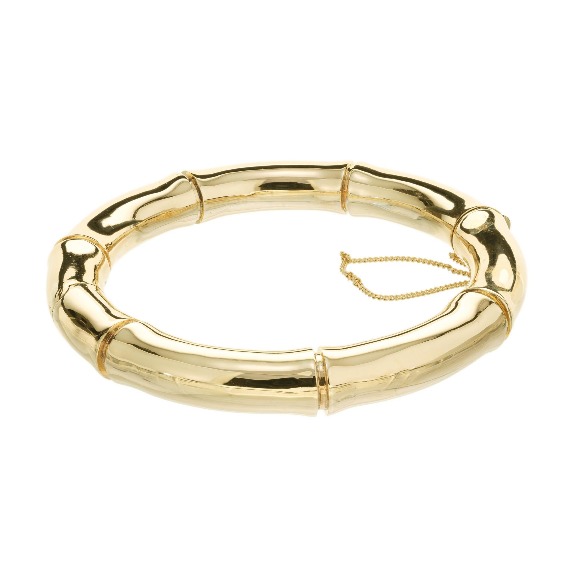 Mings hinged bamboo design 9mm wide bangle bracelet in 14k yellow gold. Fits a 7.5 Inch Wrist. Circa 1950

14k yellow gold 
Stamped: 14k
Hallmark: Mings
43.6 grams 
Width: 9.7mm
Thickness/depth: 9mm
Inside dimensions: 2.5 Inch x 2.5 Inch
Shape: