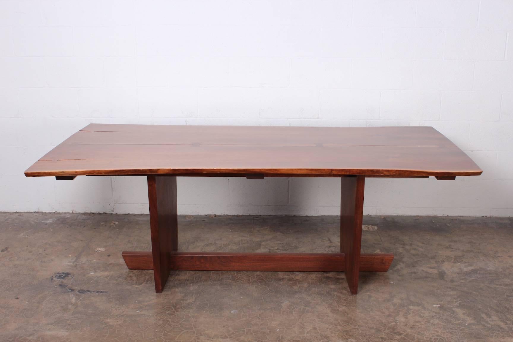 A walnut, Minguren II dining table with rosewood bowties by Mira Nakashima, 2005.
Signed and dated.