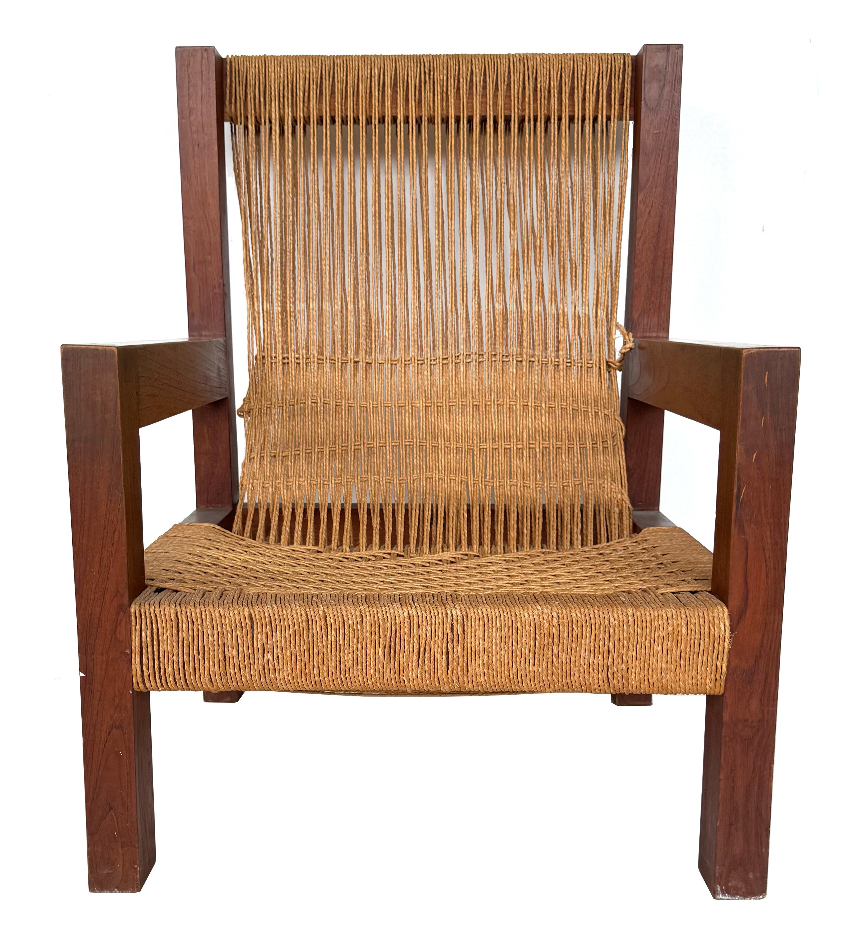 A truly special chair.   Designed by Mini Boga for Taaru in Delhi , India ca. 1970.  
This example with the rare high back in solid teak and with the original rope weaved seating.    An incredibly comfortable and inviting chair.    A low lounge with