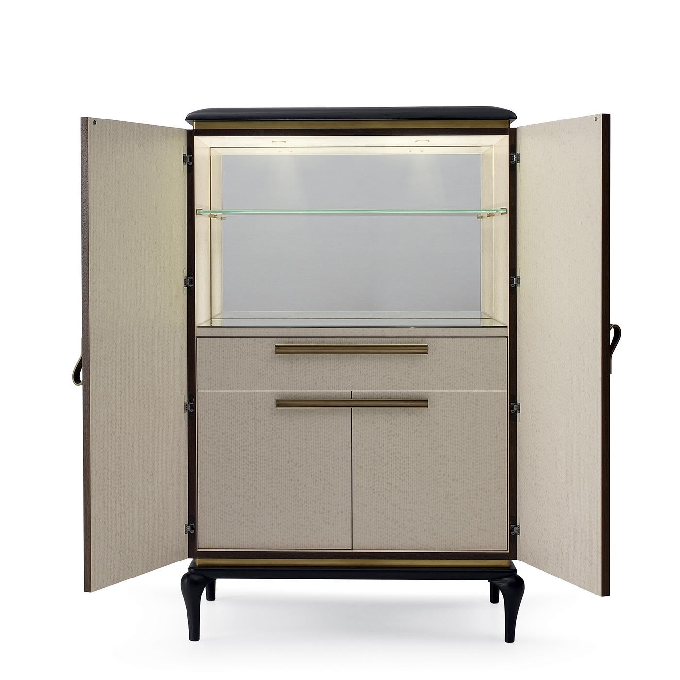 An elegant cabinet by Piero Lissoni will be a stylish addition to both a modern or Classic decor. Crafted with a solid frame of plywood and ashwood and Canaletto walnut-veneered MDF, this piece is enriched with burnished brass handles and solid ash