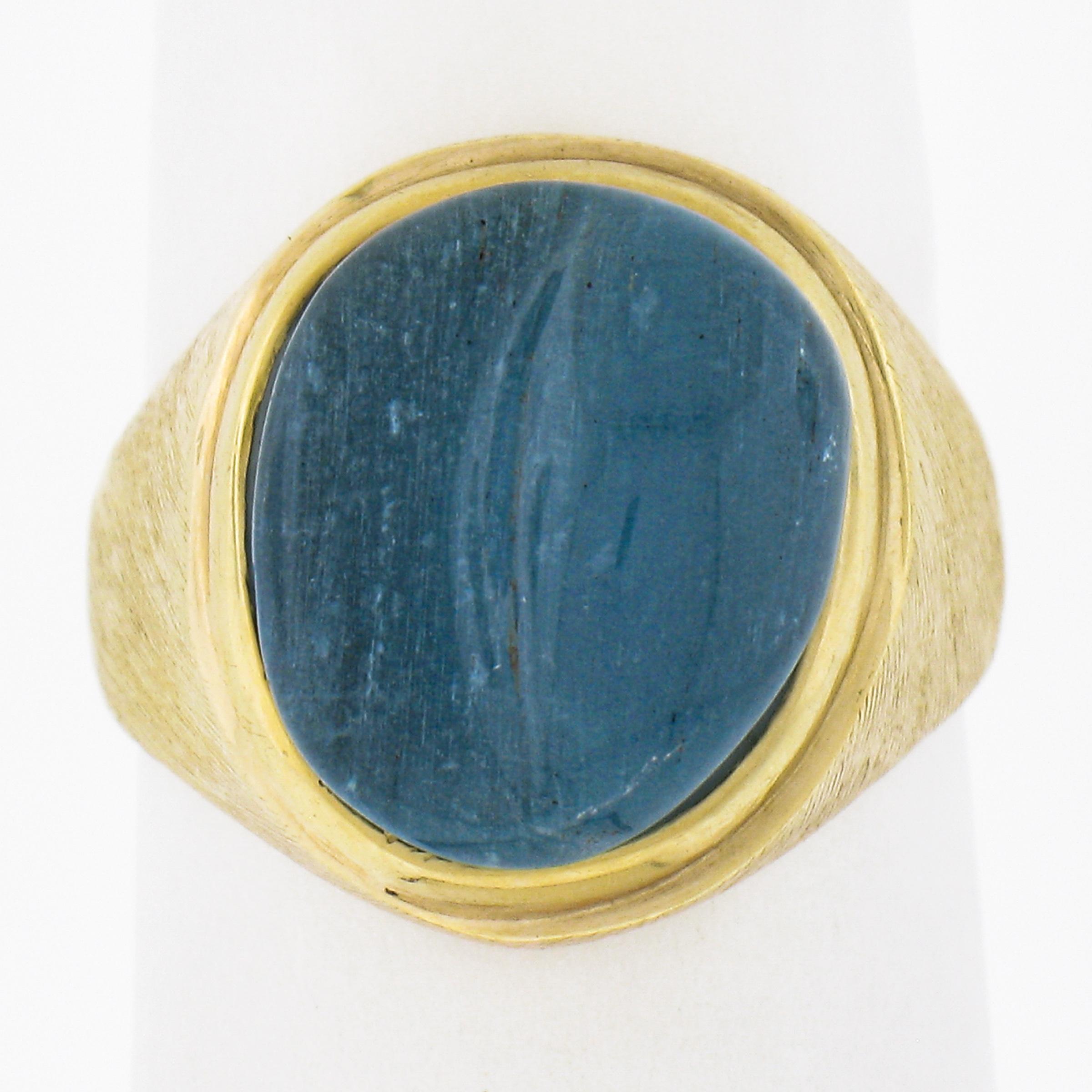 --Stone(s):--
(1) Natural Genuine Carved Aquamarine - Oval Cabochon Cut - Bezel Set - Deep Blue Color - 12.7x10.8mm (approx.)

Material: Solid 18k Yellow Gold
Weight: 5.86 Grams
Ring Size: 4.5 (Fitted on a finger. We can NOT custom size this