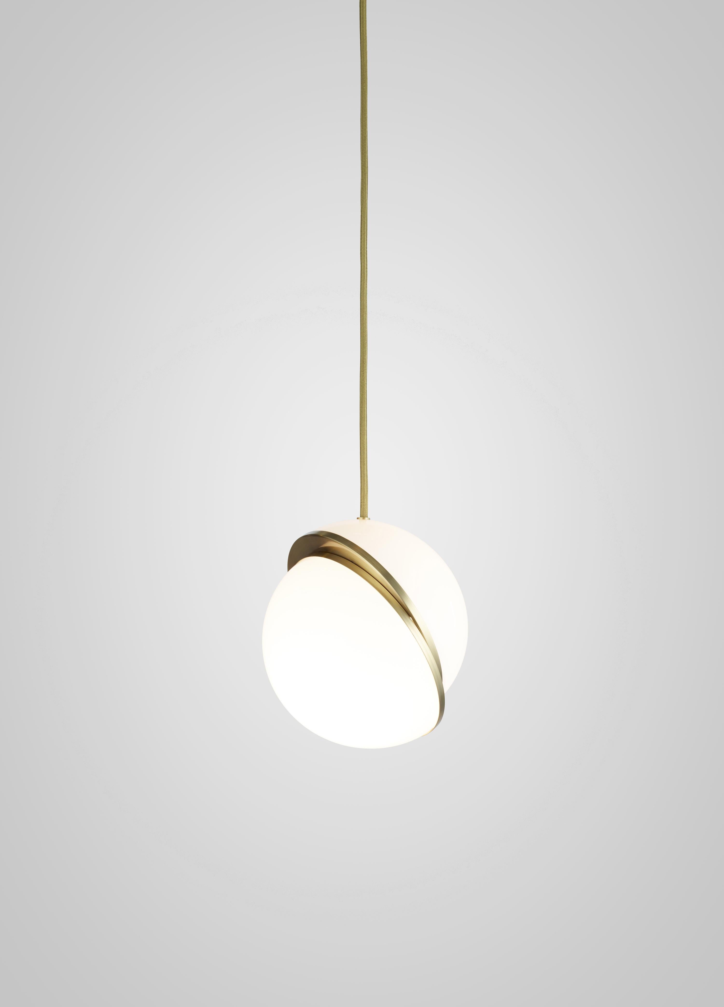 A miniature version of the popular Crescent Light, this illuminated sphere is sliced asymmetrically in half to reveal a crescent-shaped brushed brass fascia. ­The Mini Crescent Light seamlessly combines the solid and the opaque. Also available as a