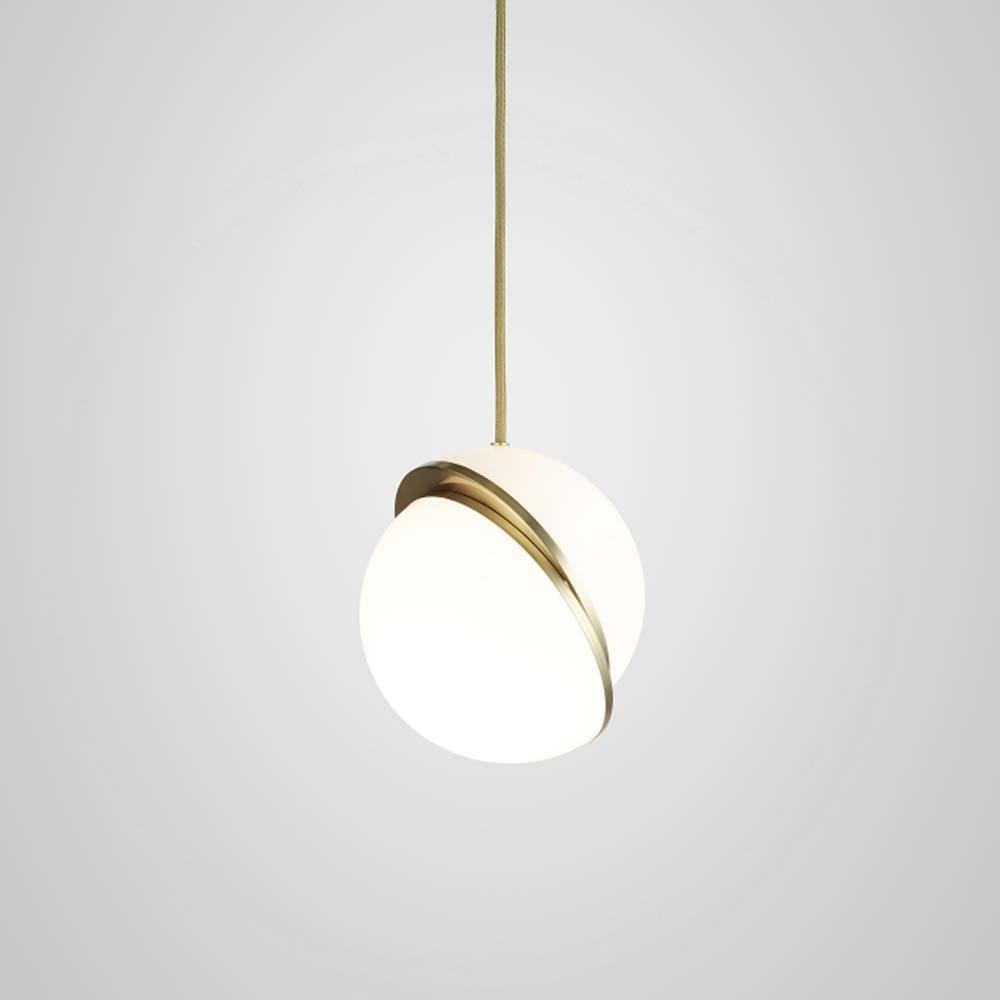 A miniature version of the popular Crescent Light, this illuminated sphere is sliced asymmetrically in half to reveal a crescent-shaped brushed brass fascia. Mini Crescent seamlessly combines the solid and the opaque. The brass combined with opaque