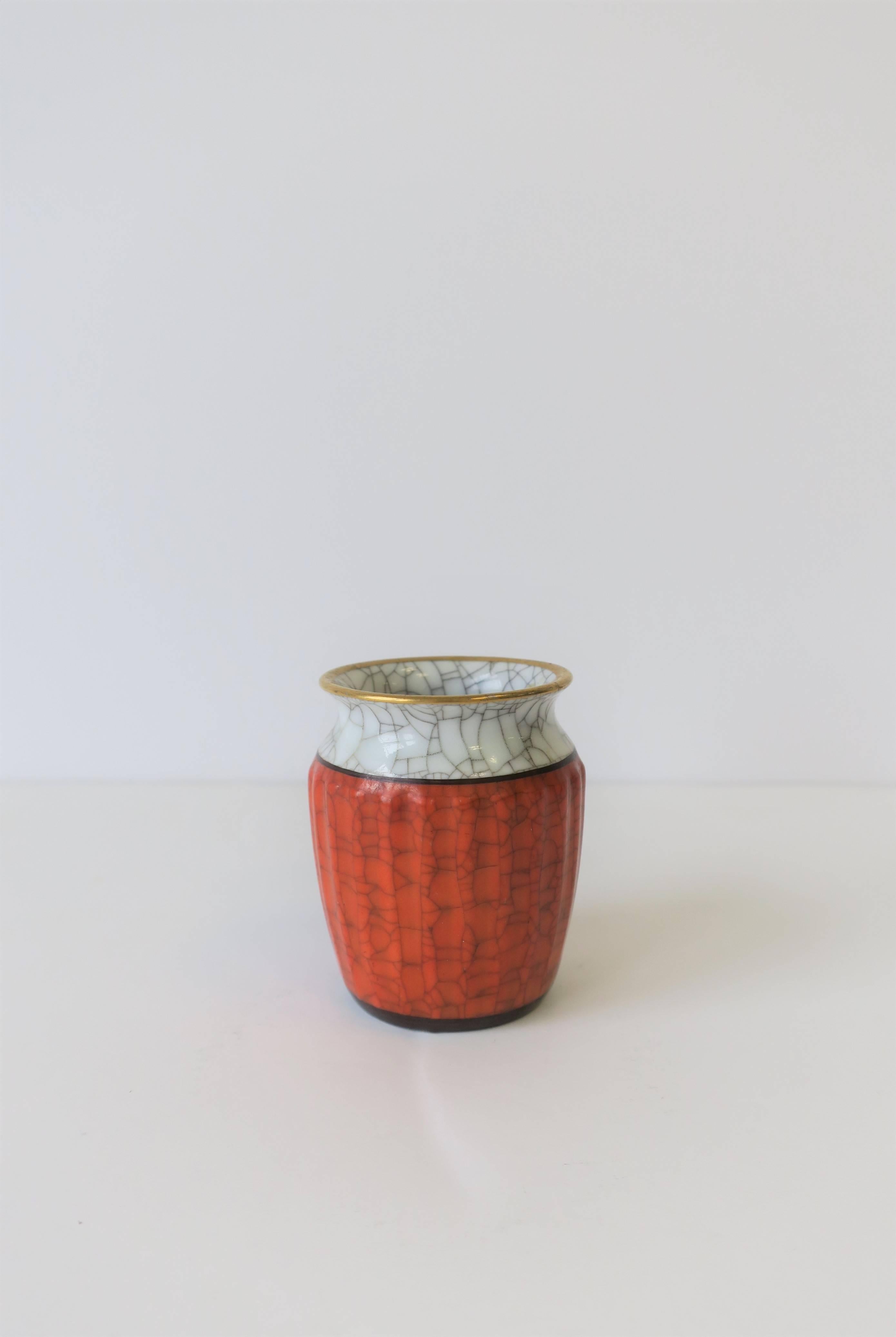 A beautiful, small Danish vase in white and orange ceramic porcelain, with a gold rim, fluted body and a 'cracked' design. Marked (Denmark) and numbered on bottom as shown in last image. Vase measures 2.25