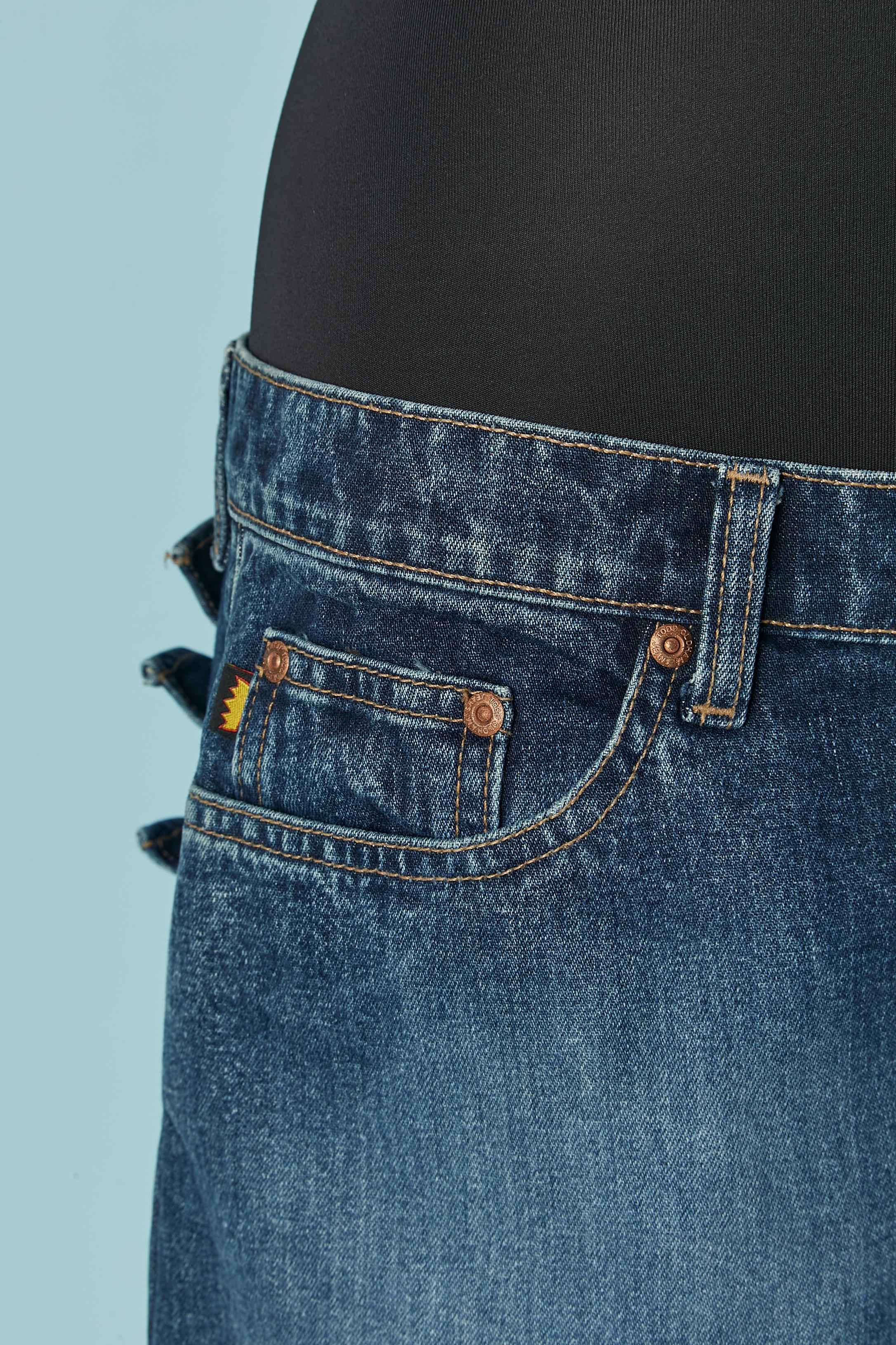 Mini denim skirt with ruffles on the back . Branded button, buttonhole and zip closure on the middle front. 
Pocket on both side on the front with branded studs. 
SIZE L 