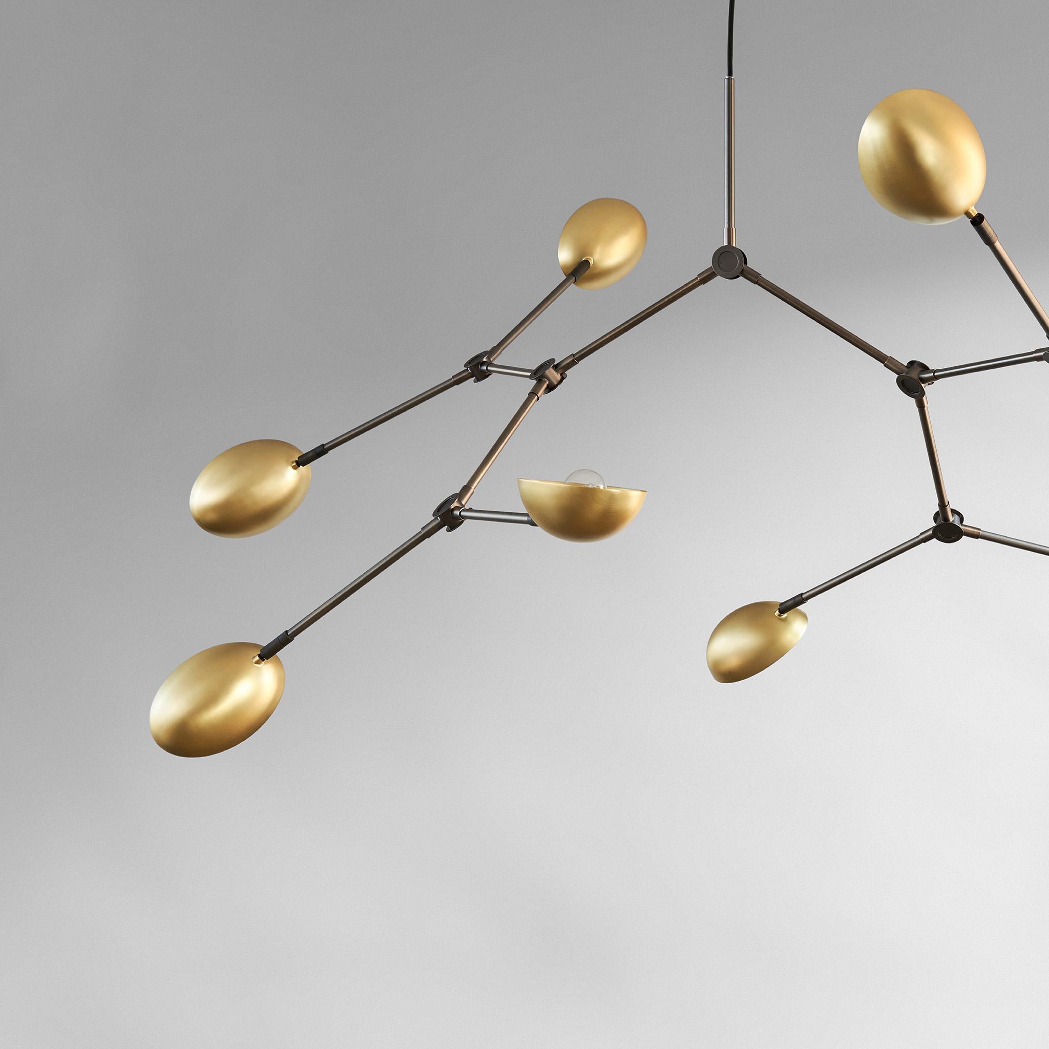 Mini Drop chandelier brass by 101 Copenhagen
Designed by Kristian Sofus Hansen & Tommy Hyldahl.
Dimensions: H95 x L100 x W95 CM
Materials: Brass; Lampshade & Ceiling cup: 100% Iron, with the plated brass finish; Pipes & attachment parts are made of