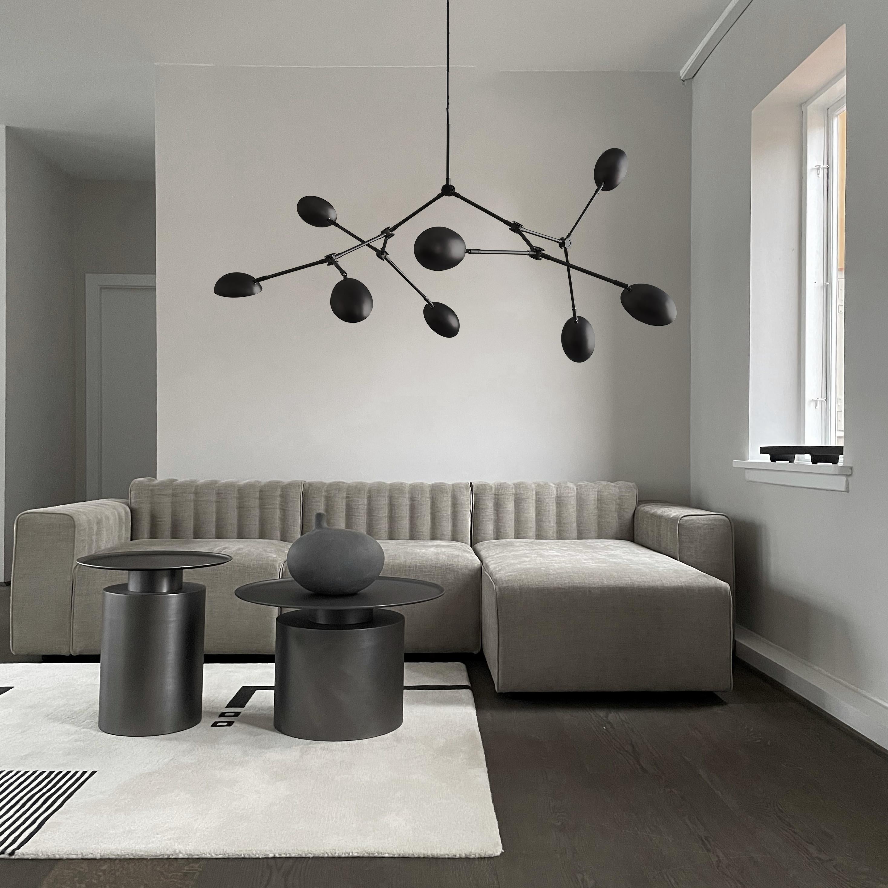 Mini Drop Chandelier Oxidized Metal by 101 Copenhagen
Designed by Kristian Sofus Hansen & Tommy Hyldahl.
Dimensions: L100 x W95 x H95 cm
Materials: Lampshade: Oxidized Aluminium
Pipes: Brass Oxidized / Unpolished
Cable: Fabric covered cable /