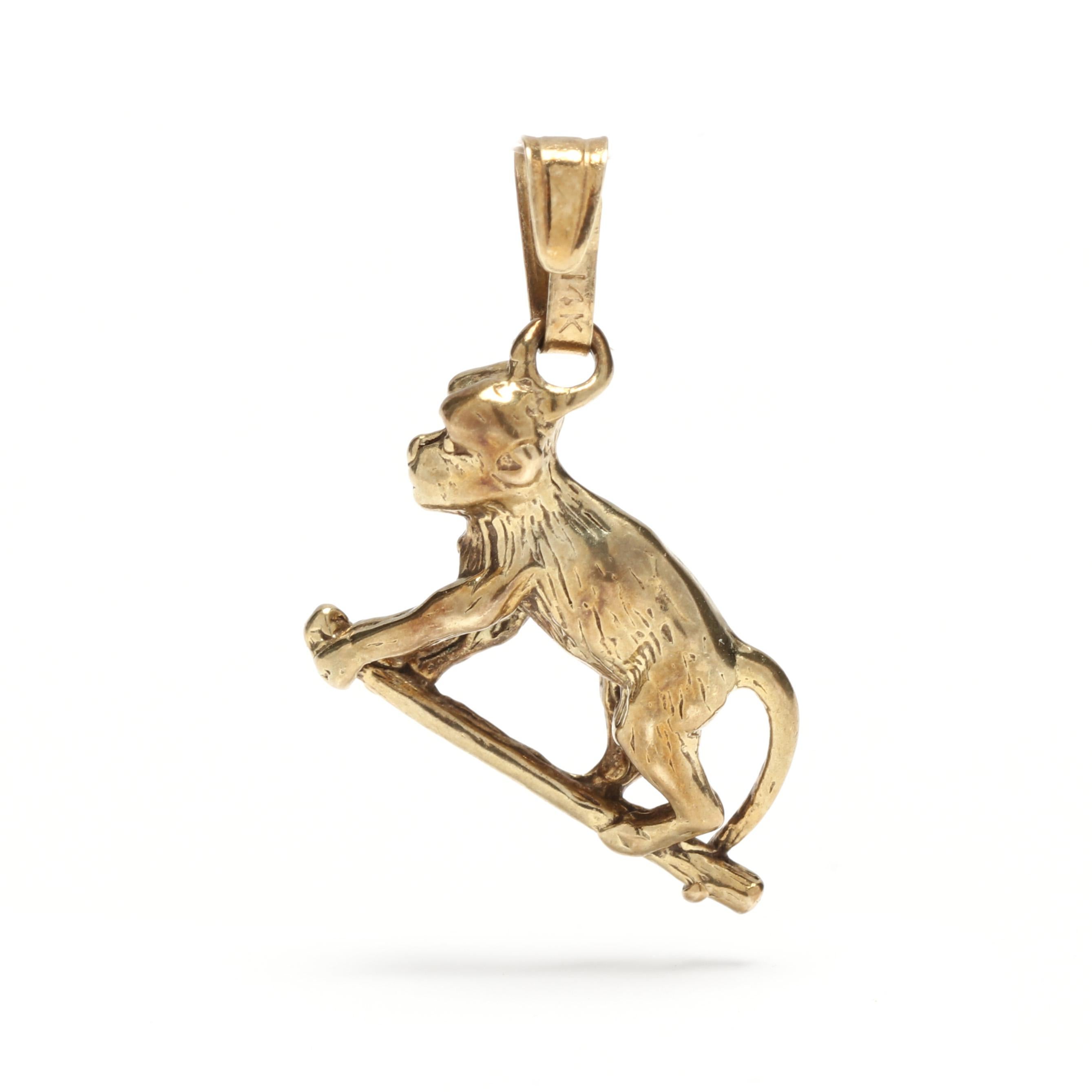 A vintage 14 karat yellow gold mini monkey charm. This small gold charm features a textured monkey motif that is climbing a limb and with a tapered bail.

Length: 5/8 in.

Width: 1/2 in.

Weight: 1.2 dwts. / 1.87 grams

Stamps: 14K

Ring Sizings &