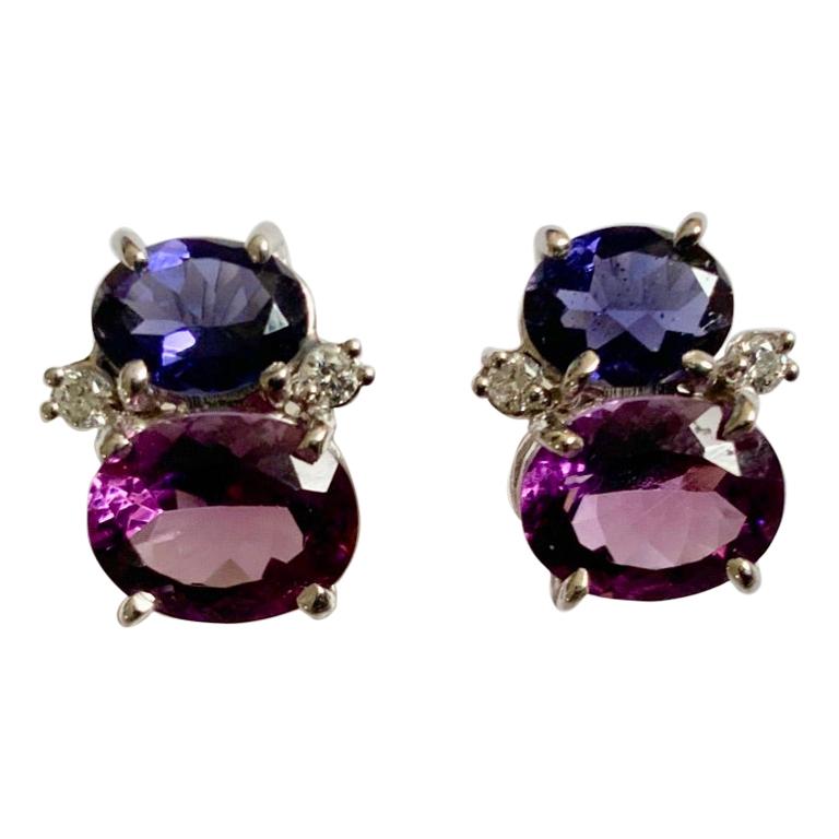 Mini 18kt white gold GUM DROP™ earrings with Iolite (approximately 2 cts each), amethyst (approximately 3 cts each), and 4 diamonds weighing 0.20 cts.

Specifications: Height: 5/8