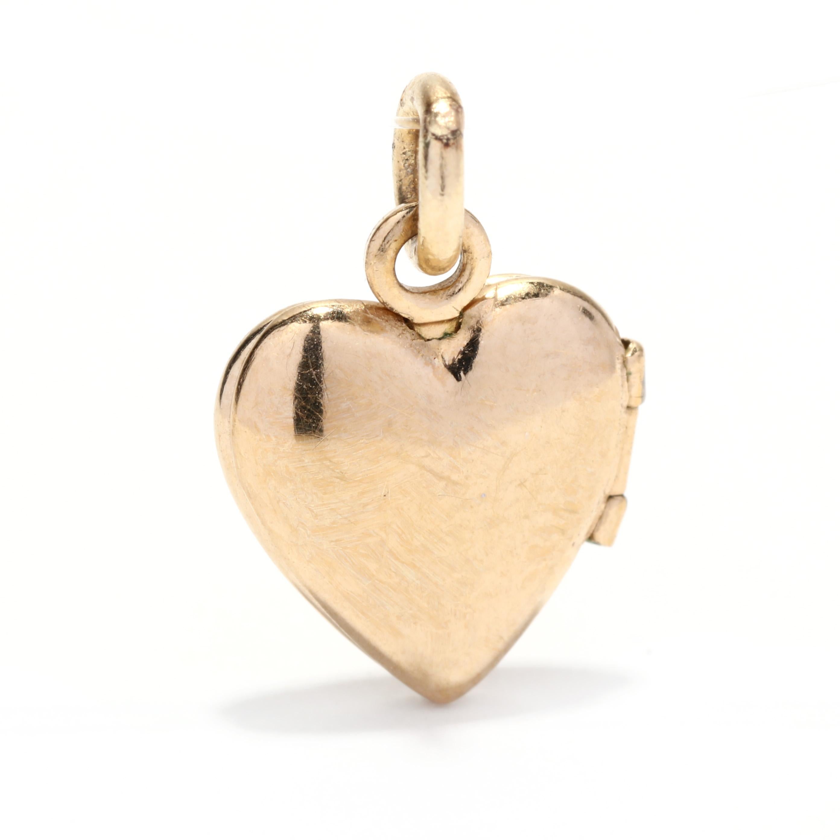 A vintage 14 karat yellow gold mini heart locket. This tiny pendant features a heart motif with engraved detailing and a thin bail.

Length: 1/2 in.

Width: 3/8 in.

Weight: .50 dwts.


Ring Sizings & Modifications:
* We are happy to assist in any