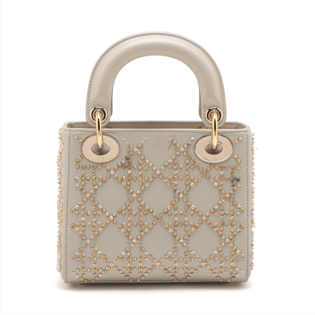 *RETAIL PRICE: $6,400**

The Christian Dior Mini Lady Dior Bag in Platinum Metallic Cannage Lambskin with Beaded Embroidery is a captivating and luxurious accessory that exudes elegance. Crafted from supple lambskin leather in a dazzling platinum