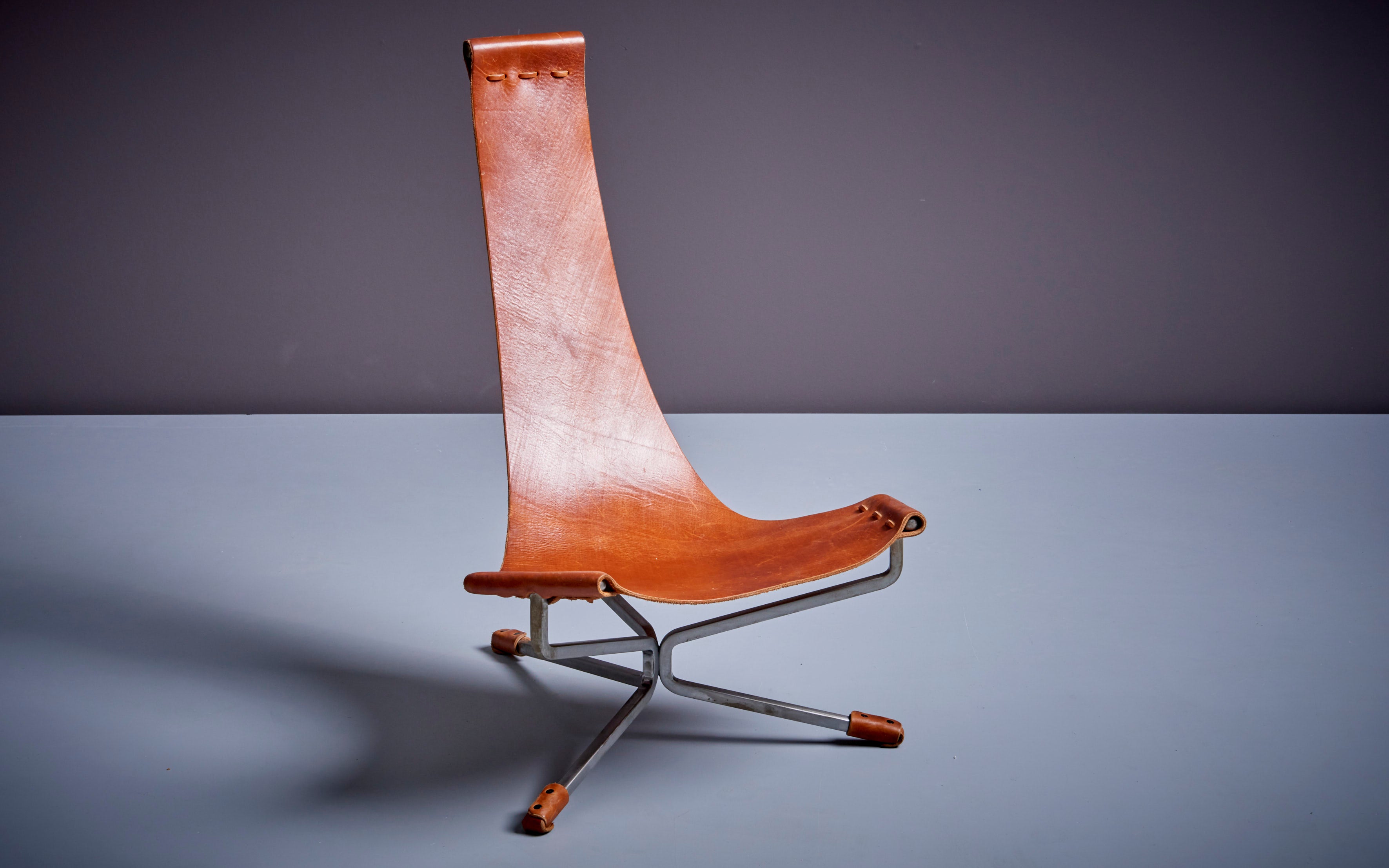 Mini Lotus chair designed by Daniel Wenger in the 1960s. Handmade during the 1970s and currently produced since 2009 by Daniel and his son Sam. Solid burnished steel frame with heavy handpicked Latigo leather sling.

Dan Wenger is an American