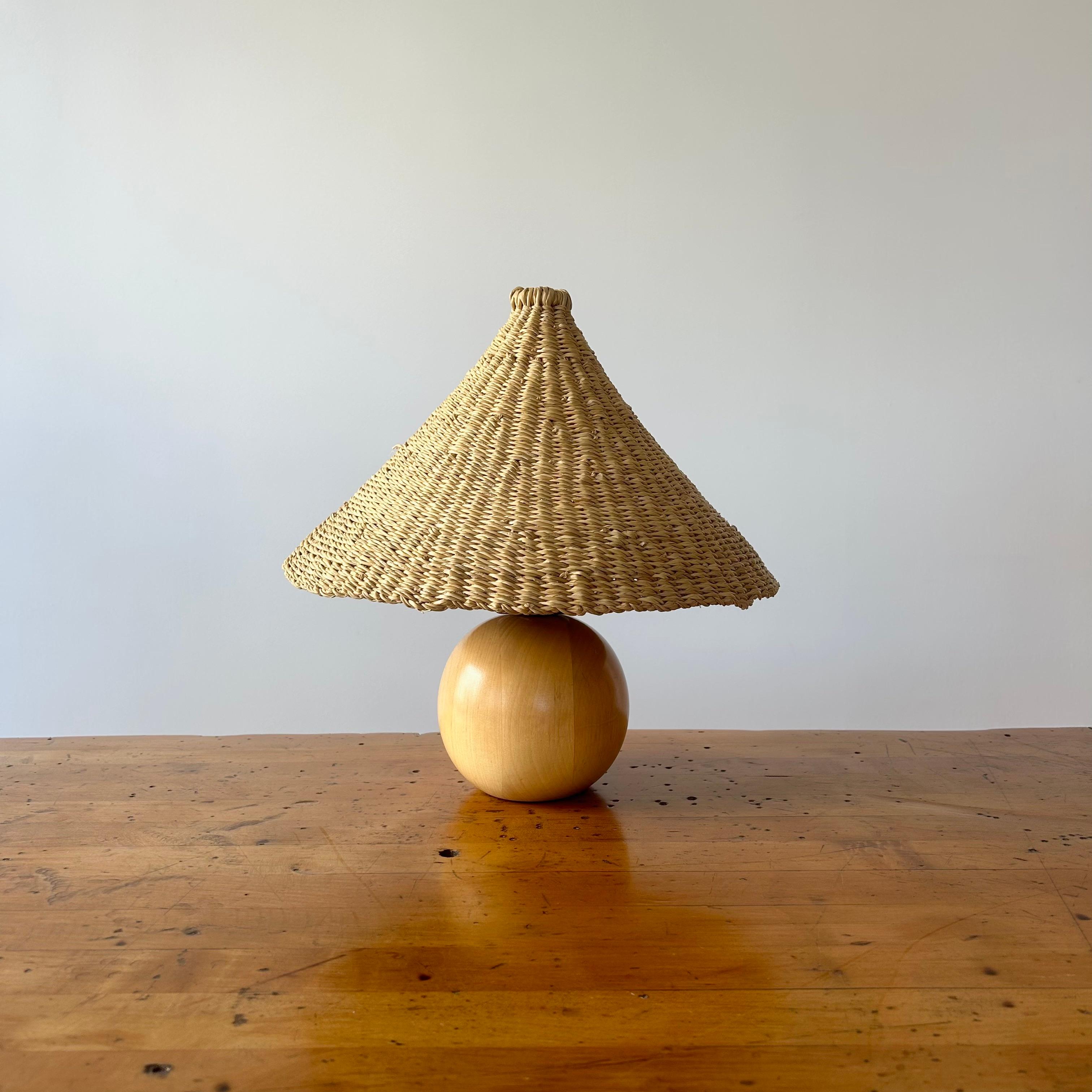Sweetly sized vintage oak table lamp from the Netherlands circa 1980s. Good vintage condition. Rewired in LA and refreshed with our elephant grass shade. One available. 

The light shade was handwoven by a women's organization for traditional arts