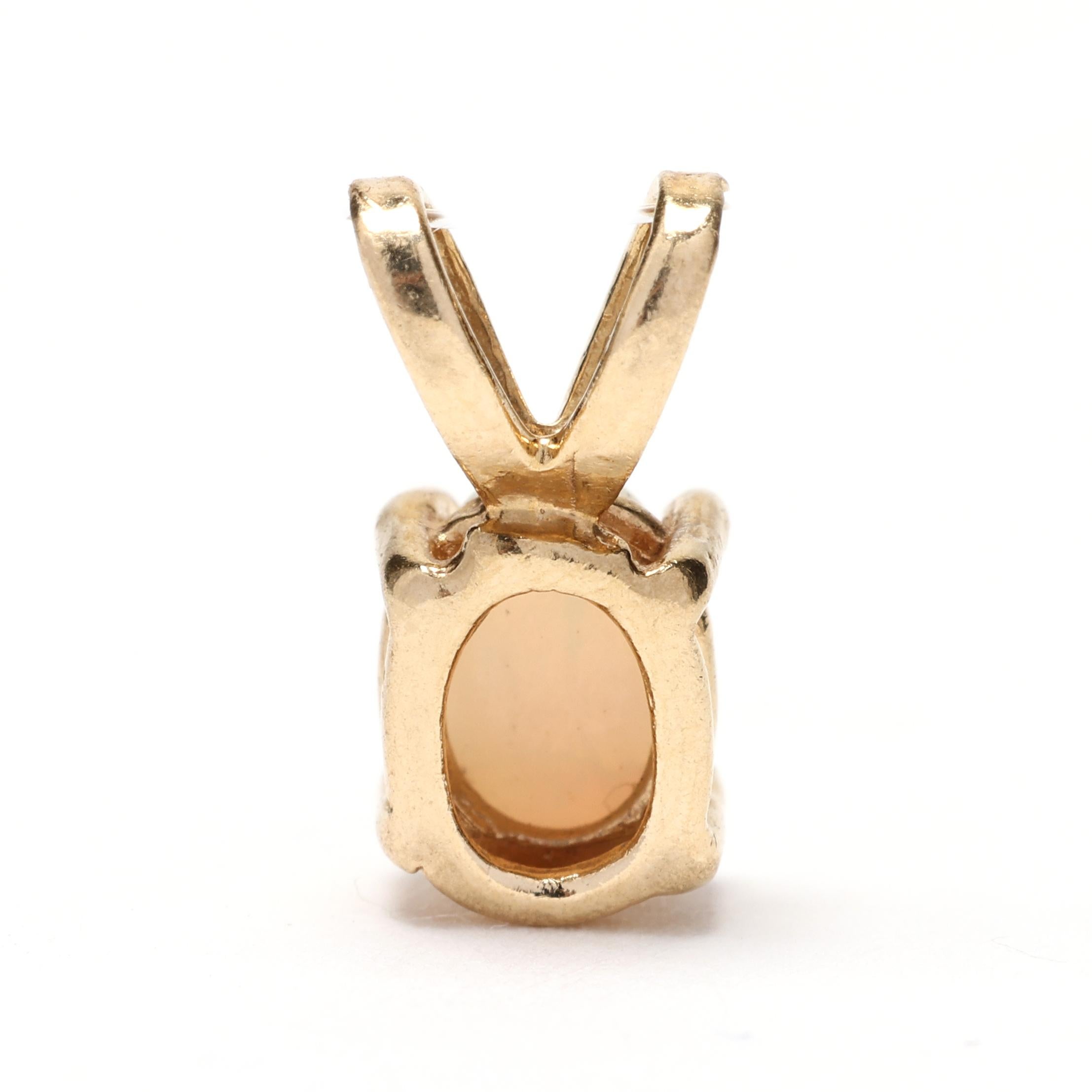 This delicate mini opal charm is crafted from 14k yellow gold, making it a beautiful and elegant addition to any jewelry collection. The small and dainty design of this pendant charm is perfect for adding a touch of sparkle to any outfit. This teeny