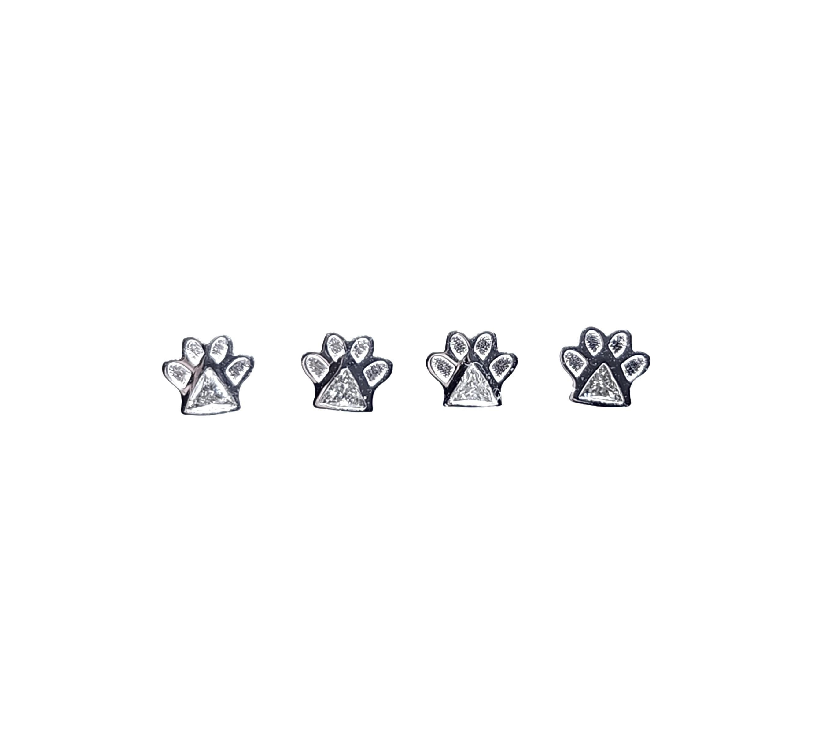 A client asked me to design a mini Paw Print stud earring with diamond so that she could wear multiples in her piercings. Perhaps the smallest size earring I have is the Baby Gingko which also can be worn in multiples.
I selected a Trilliant Diamond