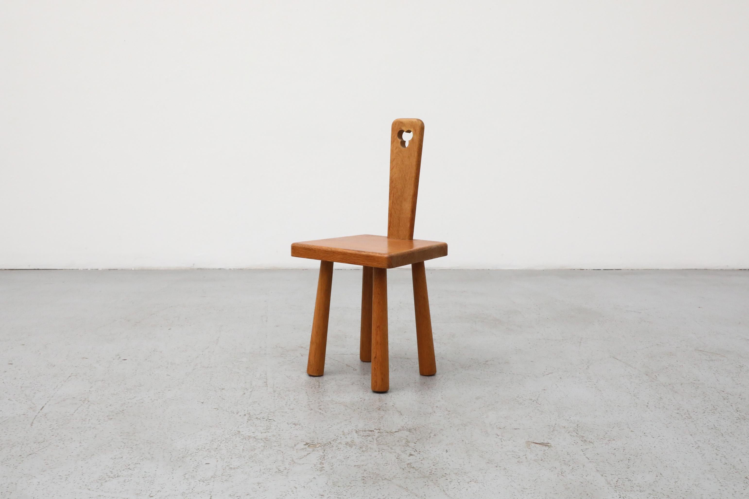 Charming Mini Brutalist solid oak fireside chair in the style of renowned French designer Pierre Chapo. This small-scale accent chair features a bold yet refined silhouette, crafted entirely from solid oak with visible joinery and reverse tapered