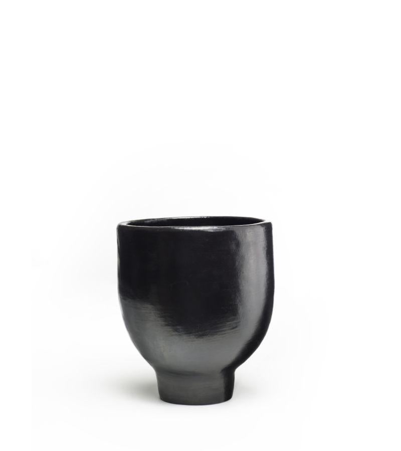 Mini Pot 1 by Sebastian Herkner
Materials: Heat-resistant black ceramic. 
Technique: Glazed. Oven cooked and polished with semi-precious stones. 
Dimensions: Diameter 17 cm x Height 20 cm 
Available in sizes large and small. 

This pot belongs