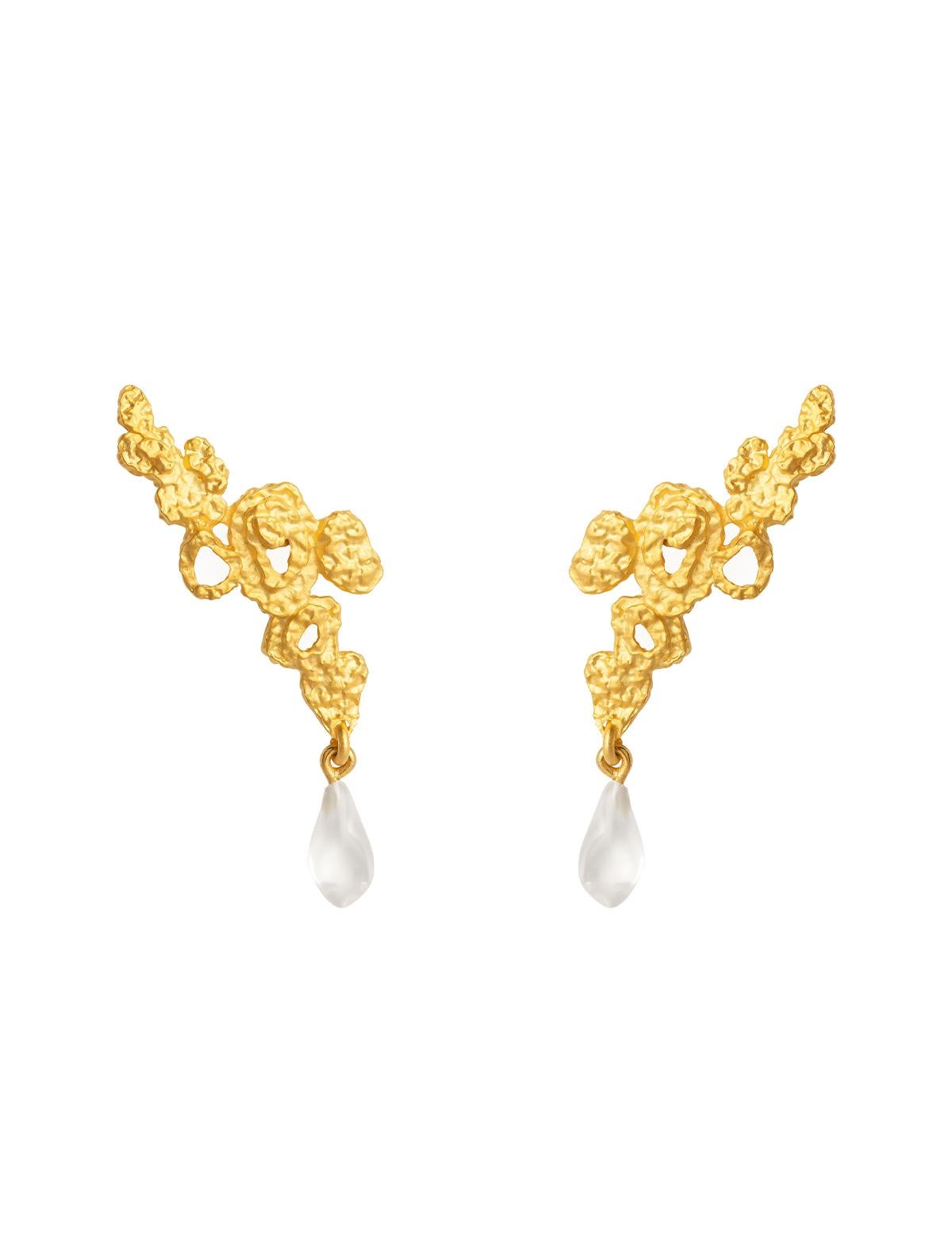 Product Details
A string of clustered irregular spirals that travel up the lobe, and dangle past the ear with a glistening transparent, irregularly-shaped resin stone. The Mini Riverstone Earrings are an elegant metaphor for the mix of precious and