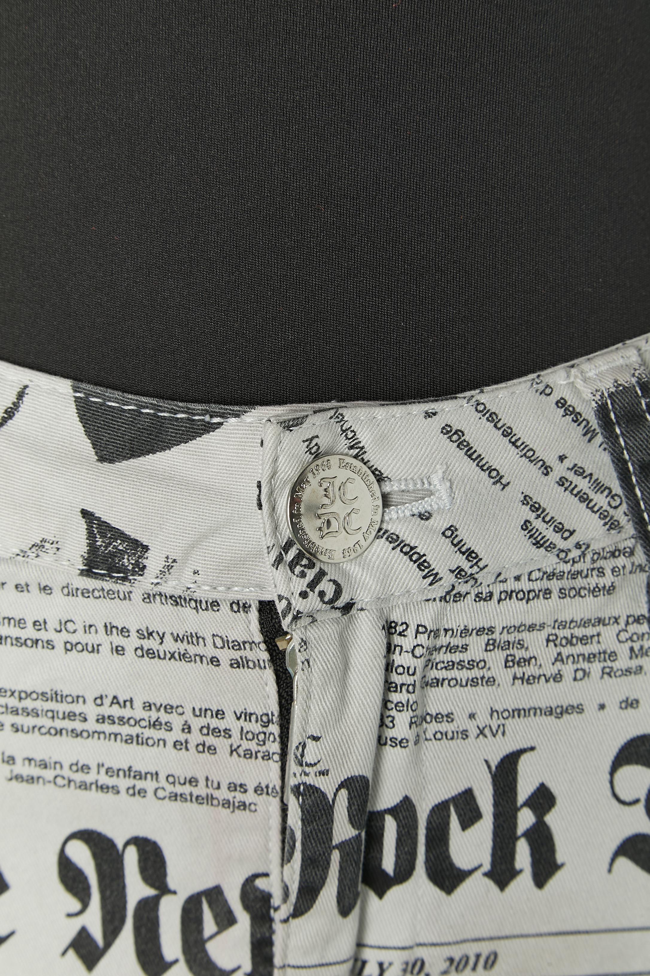 Mini skirt in cotton with newspaper print. Fabric composition: 98% cotton, 2% elasthane. Pocket on both side on the front with zip closure and branded zip puller? Branded button, buttonhole and zip closure on the middle front. Belt-loop. 
SIZE 40
