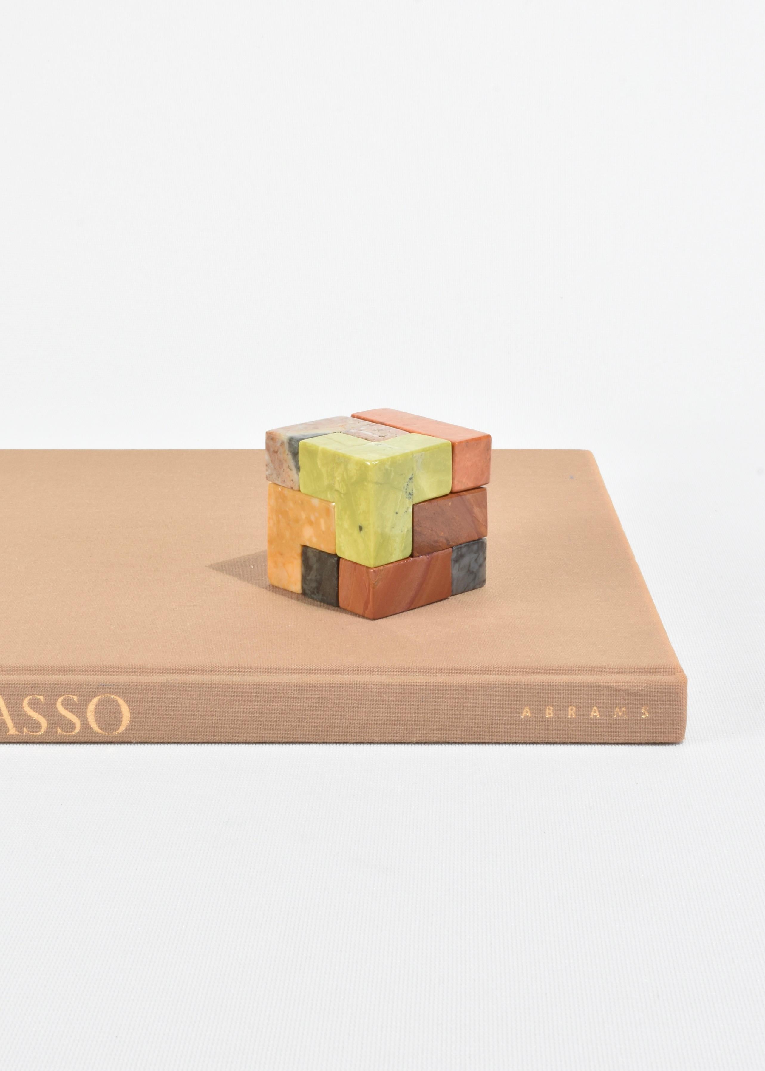 Hand-carved soma cube puzzle sculpture in a mix of 7 brightly colored semi-precious stones that form a perfect square (with 32 ways to solve). A beautiful coffee table piece or sculptural object when not in use and the perfect gift for architects,