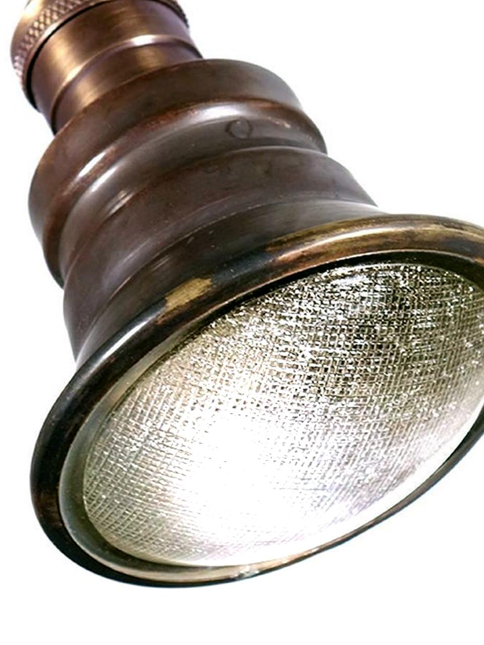 Pictured are mini spot pendants. They come in a dark brass finish. The interiors are silvered and a brass ring holds a textured glass lens. It’s has a 3.75 in. diameter. These lamps work well in numbers, hung as an informal group or in a straight