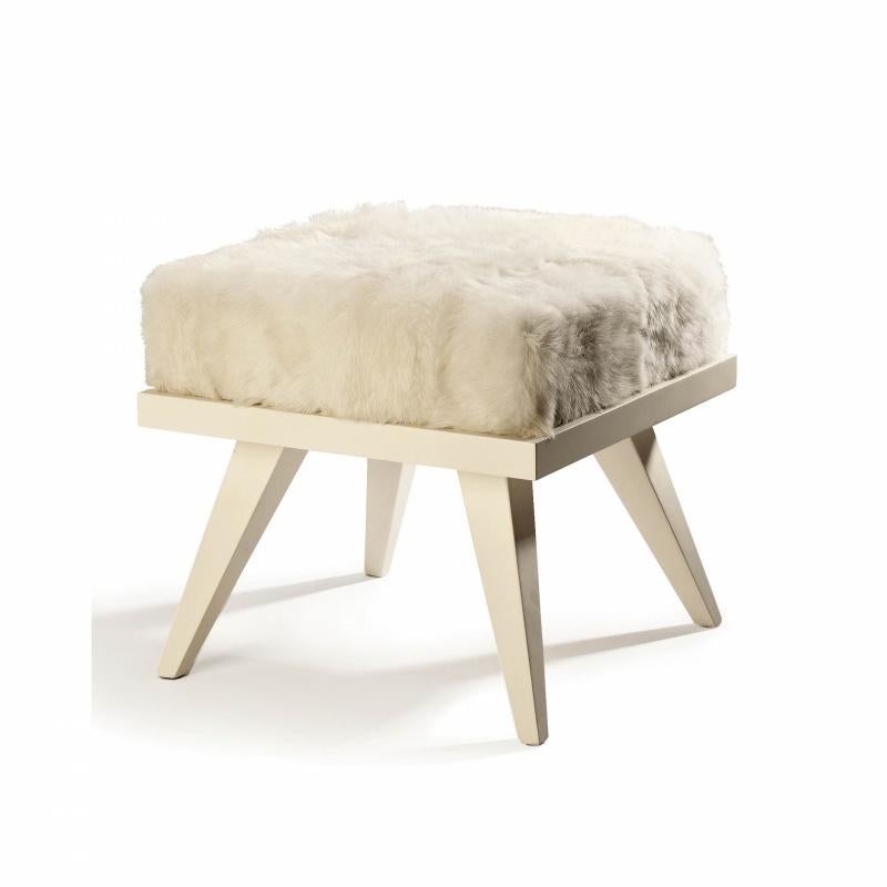 Mini stool gathers inspiration from Scandinavian design made incredibly confortable with the addition of soft upholstery. The top is upholstered in natural lamb leather and the legs are made of solid wood. Made to Order. 

