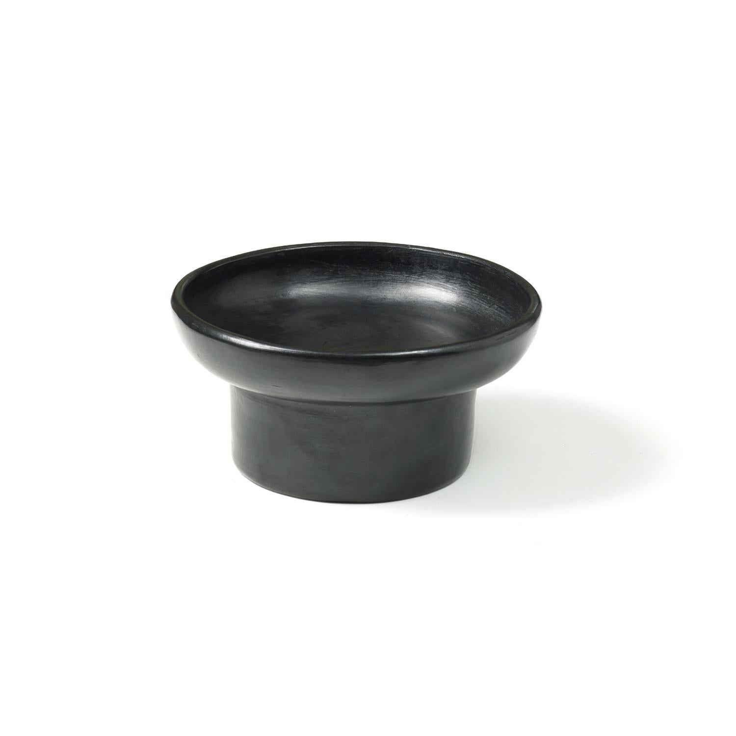 Mini tray 2 by Sebastian Herkner
Materials: Heat-resistant black ceramic. 
Technique: Glazed. Oven cooked and polished with semi-precious stones. 
Dimensions: Diameter 25 cm x height 9 cm 
Available in sizes large and small.

This pot belongs
