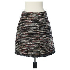 Mini tweed skirt with branded buttons on the front Chanel 
