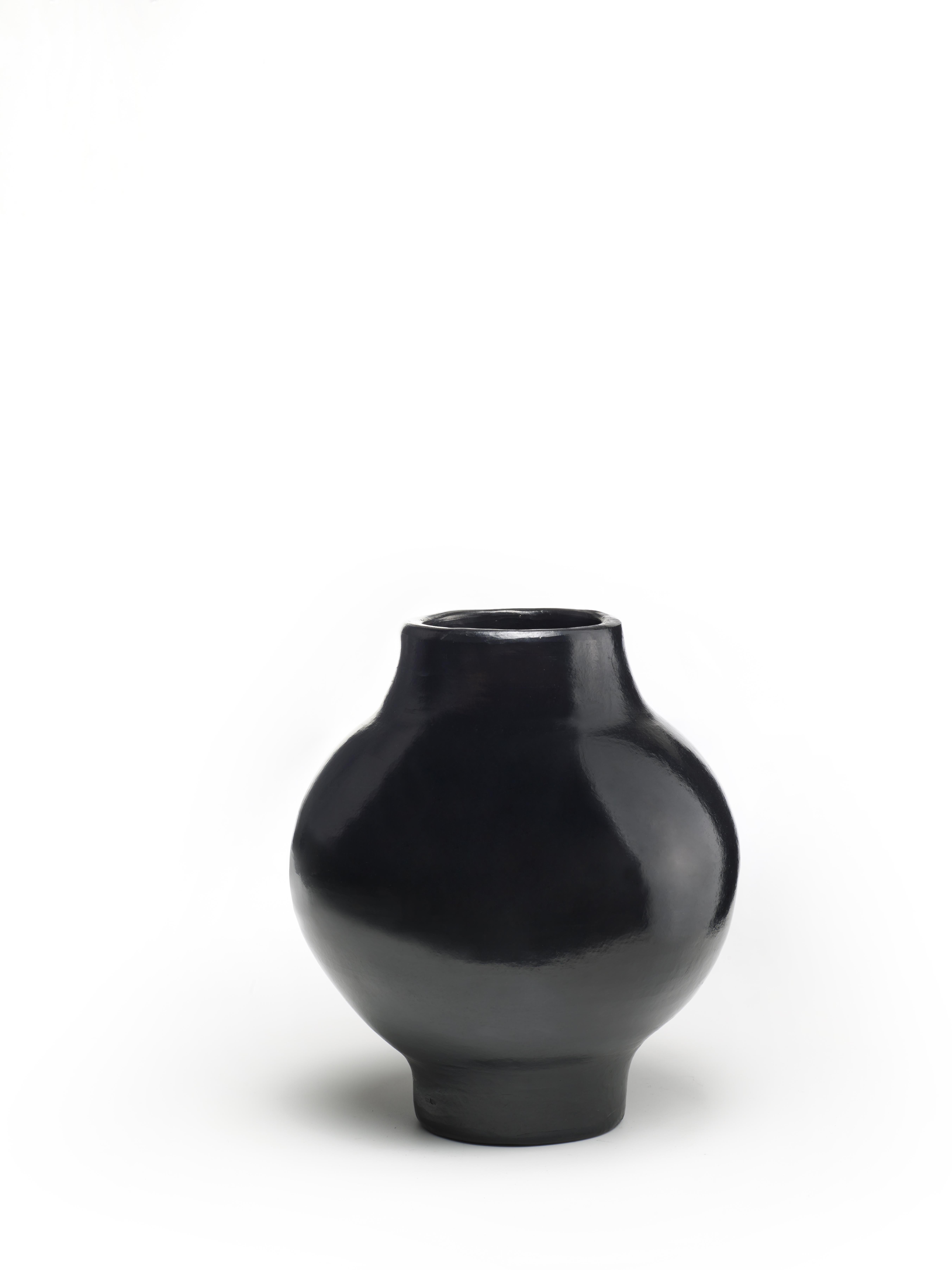 Mini Vase by Sebastian Herkner
Materials: Heat-resistant black ceramic. 
Technique: Glazed. Oven cooked and polished with semi-precious stones. 
Dimensions: Diameter 16 cm x H 19 cm 
Available in sizes large and small.

This pot belongs to the