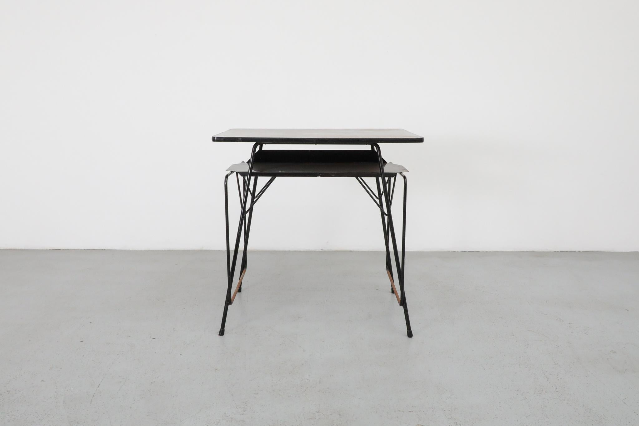 Mini Willy Van Der Meeren industrial desks for Tubax—perfect as an entry table or vanity, with a printed laminate top, black enameled metal wire frame, and black sheet metal shelf. Founded in 1948 by Jan Vits, Tubax became one of Belgium's leading