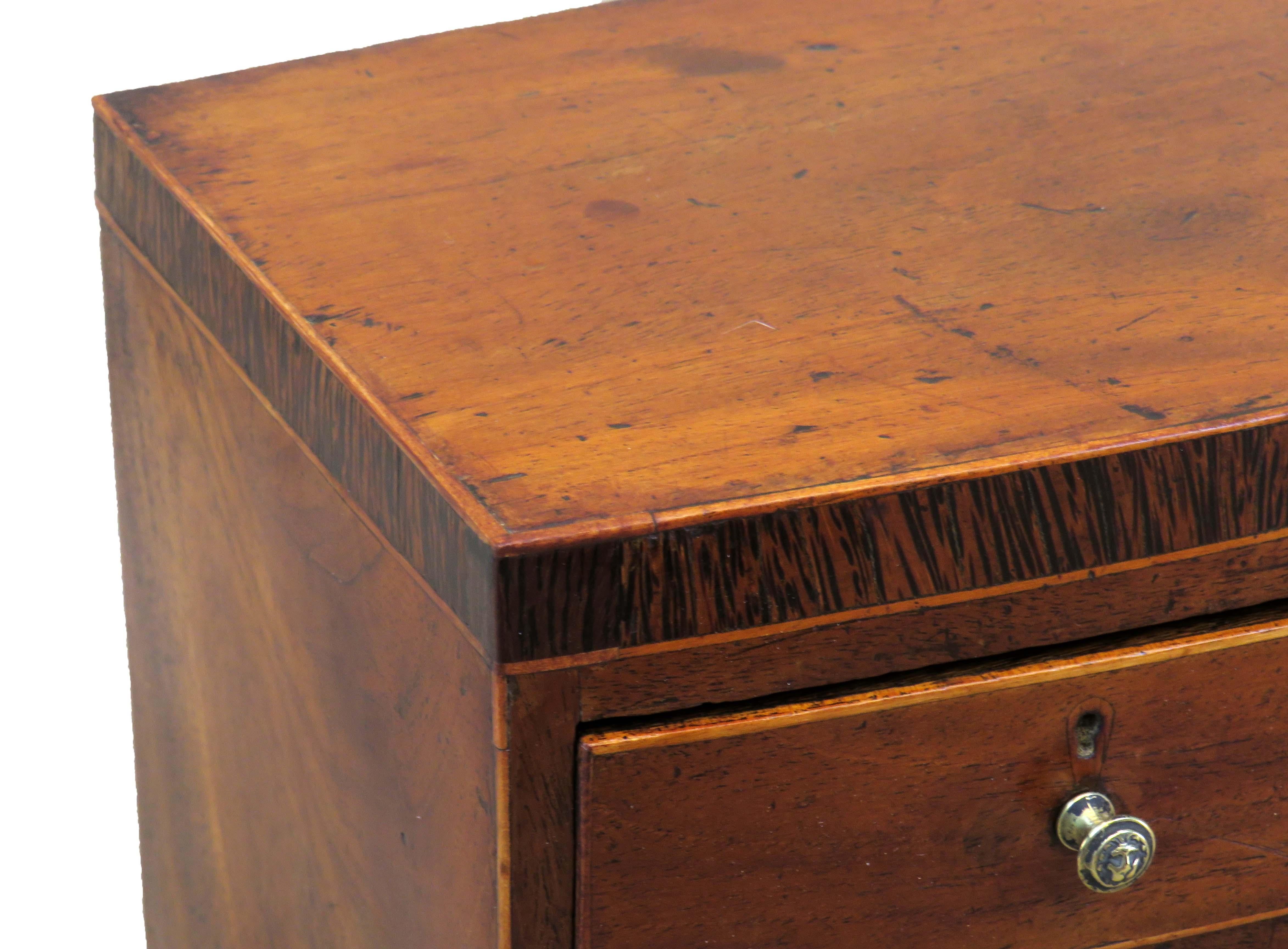 A very attractive mid-19th century mahogany
Miniature bowfronted chest with well figured
Top and crossbanded decoration over two short
And three long drawers having replaced brass
Knobs over elegant original splay feet

(There is often a