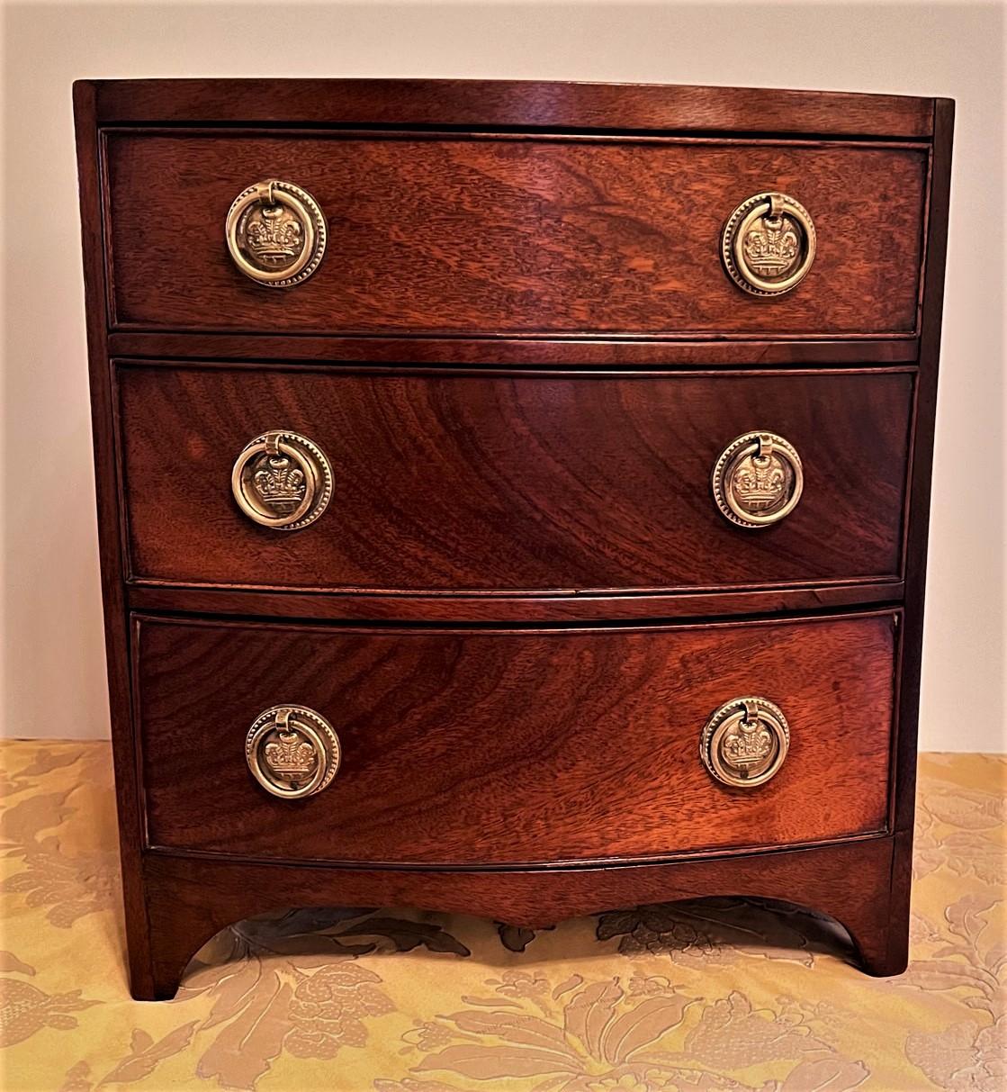 This charming little chest was hand made as a cabinet maker's sample, or more likely as a toy chest for a very privileged little girl to keep her doll's clothes in. It was made in a very skilled cabinet maker's shop using leftover mahogany from