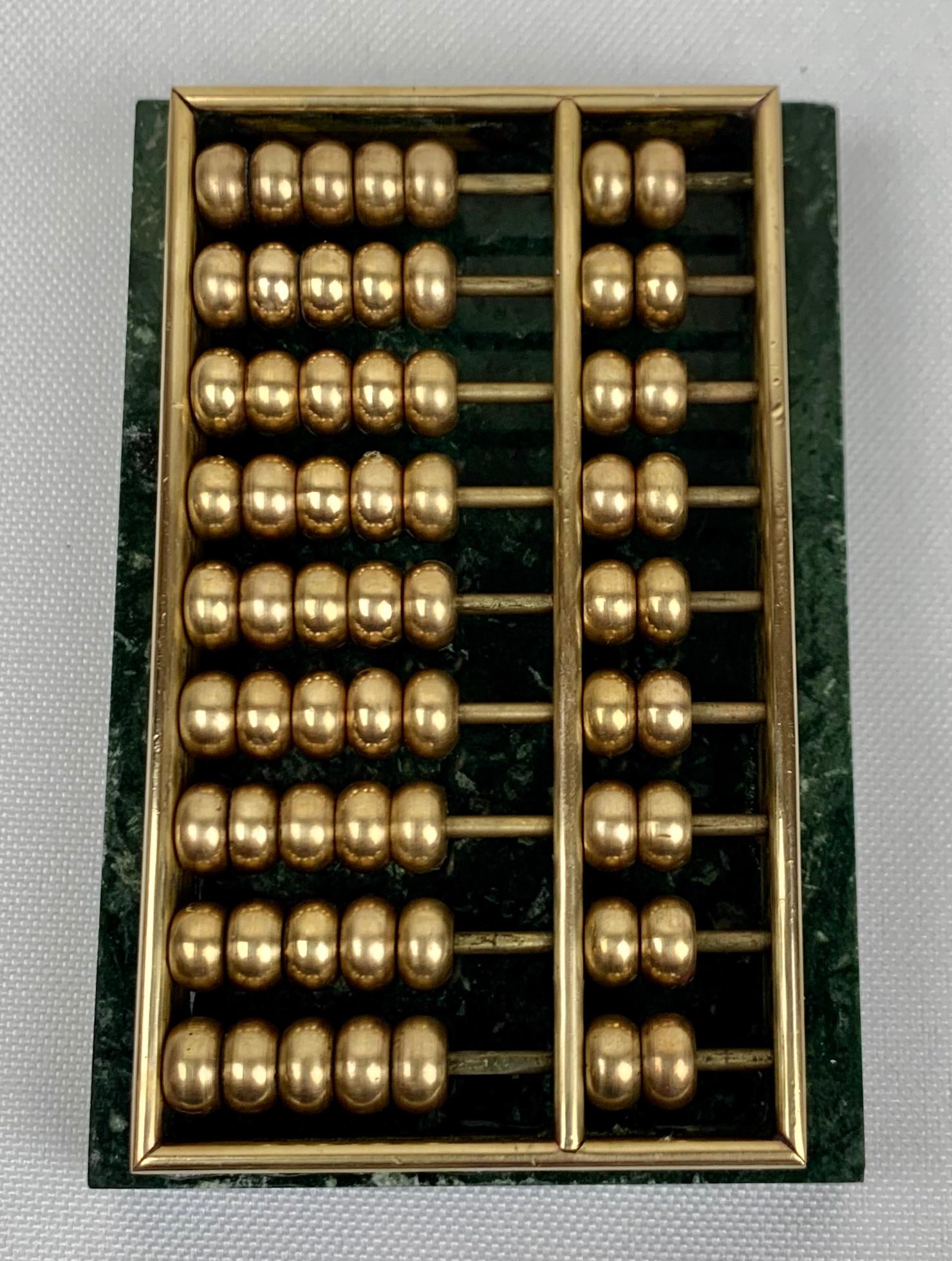 Miniature Abacus with brass accents mounted on green marble.
Mid-twentieth century.
Measures: 3 3/8