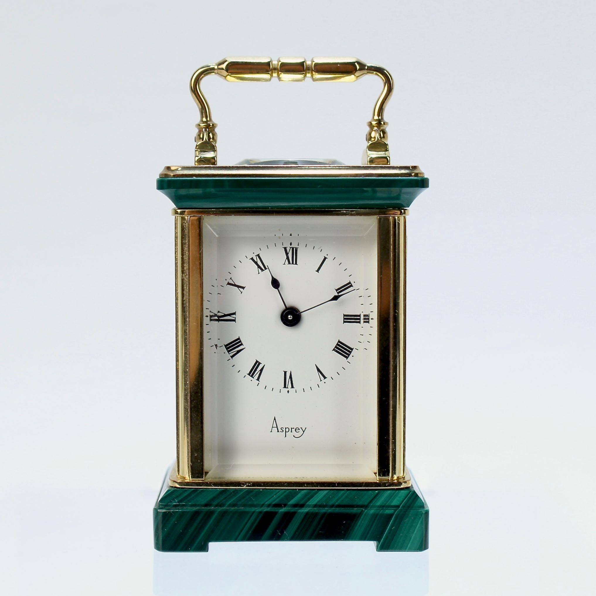 A very fine Asprey miniature carriage clock.

In brass with Malachite elements incorporated to the top and base and French works.

Marked Asprey to the face. Together with 2 associated keys for winding.

Height: ca. 2 3/4 in.

Items purchased from