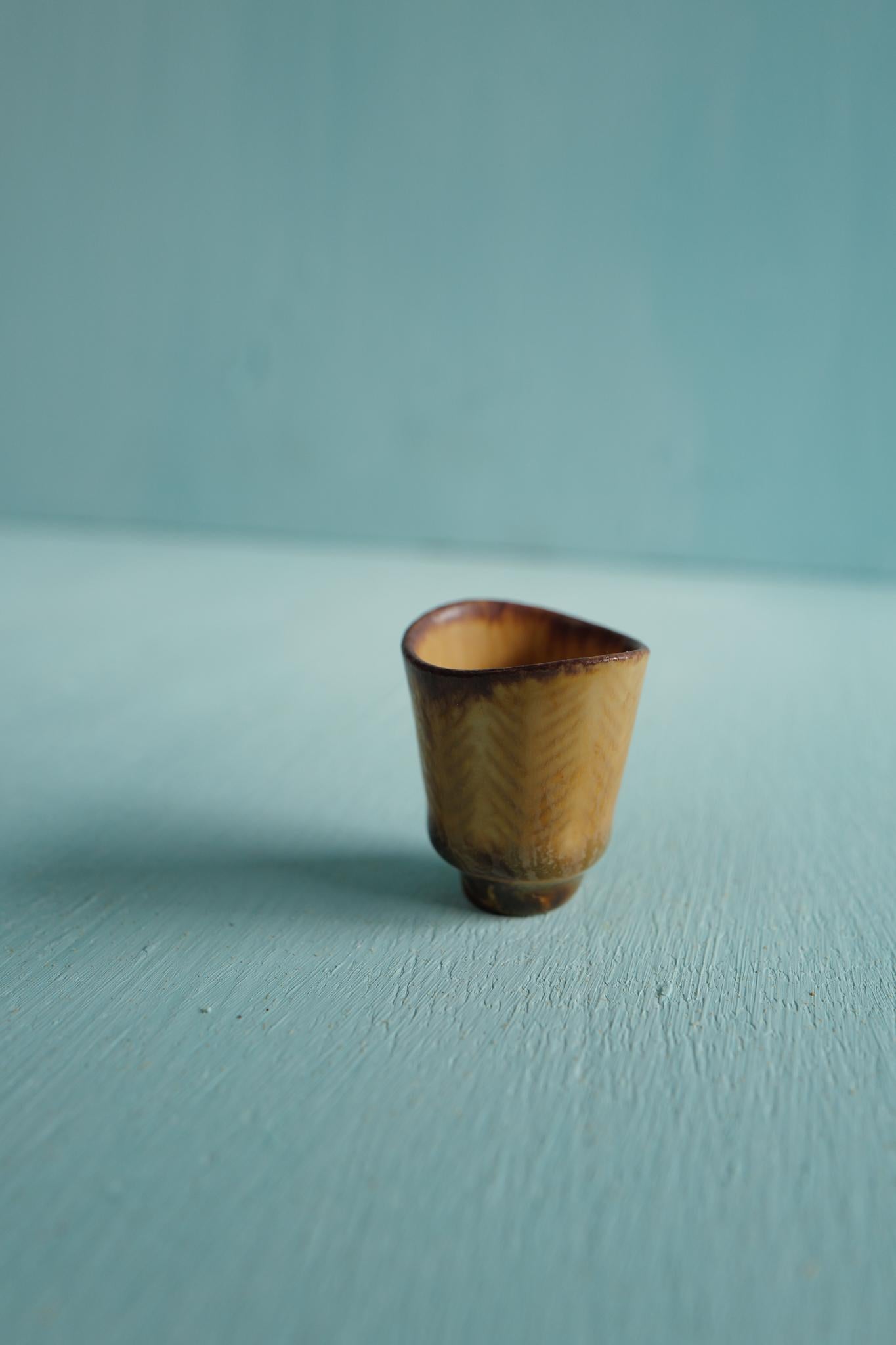 A miniature ceramic vase in earthtones designed by Carl-Harry Stålhane and produced by Rörstrand, Sweden, 1950s. 

Carl-Harry Stålhane joined Rörstrand in 1939, beginning as a decorator under Gunnar Nylund before becoming one of Sweden’s most