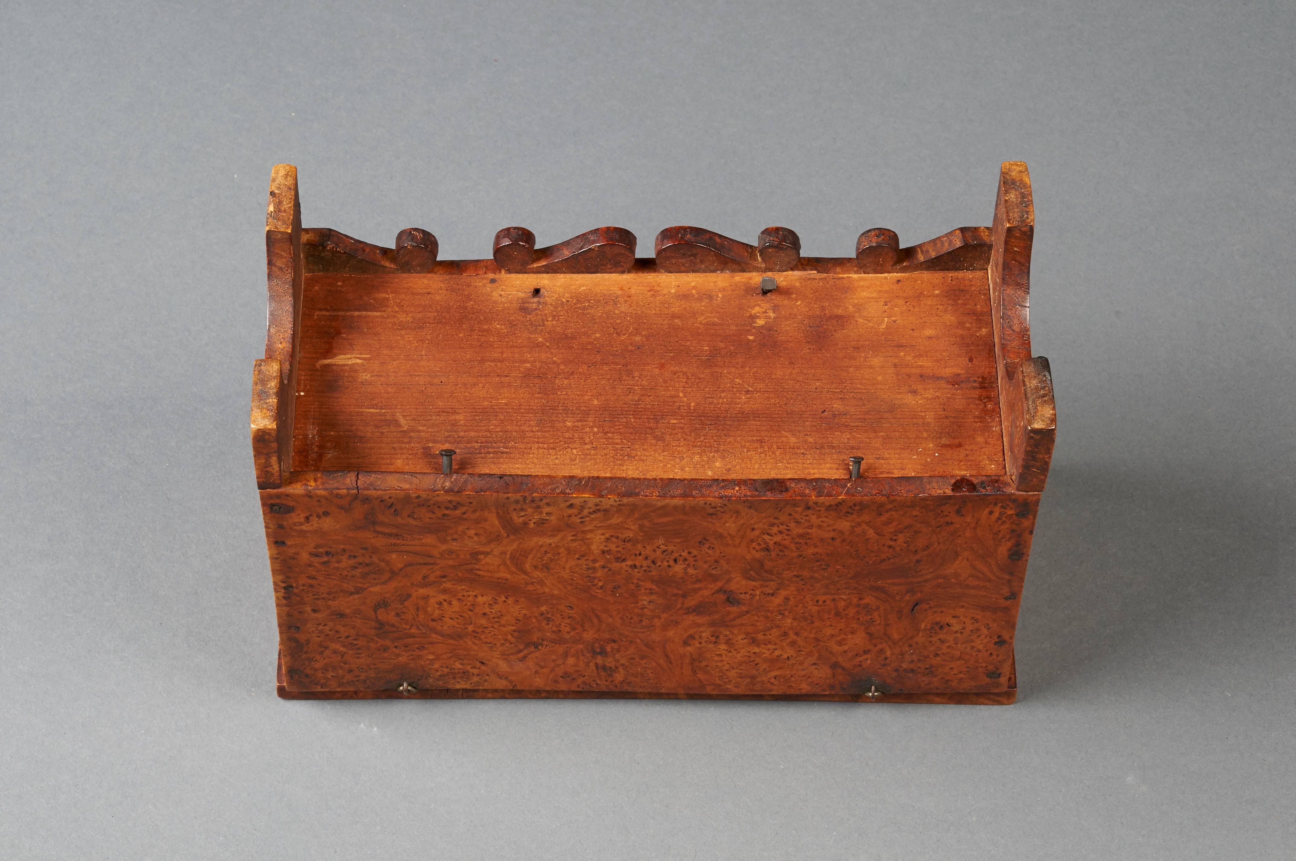 A miniature blanket chest of outstanding figured burl maple from New York. The shaped skirt and small size make this a wonderful item for table-top display. Early circa 1800 manufacture. Original condition.