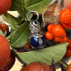 Miniature blue glass scent bottle with silver mounts. English, 17th century. A
