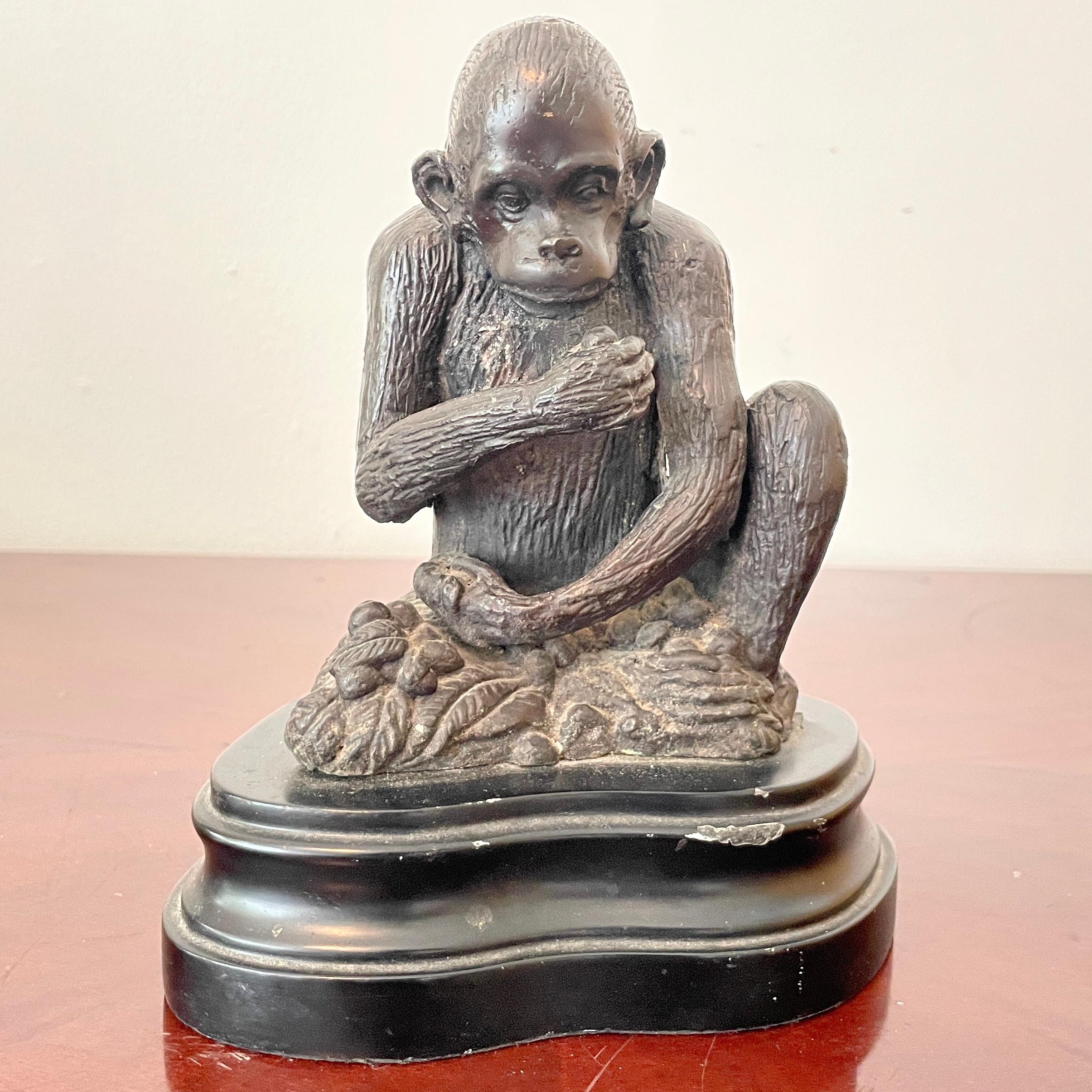 Beautiful miniature bronze statue of a monkey sitting on a base. Great addition to your table tops and interiors.