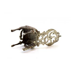 Miniature chair in cut silver with embossed top featuring a dancing figure