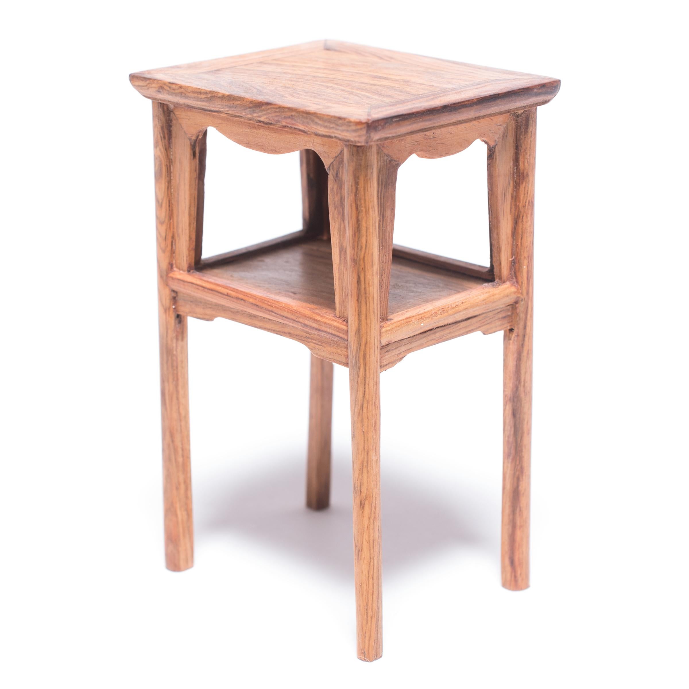 A full size table with this level of workmanship would be an incredible find, but this beautiful piece of furniture—at only four inches tall—is perfectly constructed down to the tiniest minutia. The table was crafted in northern China from a