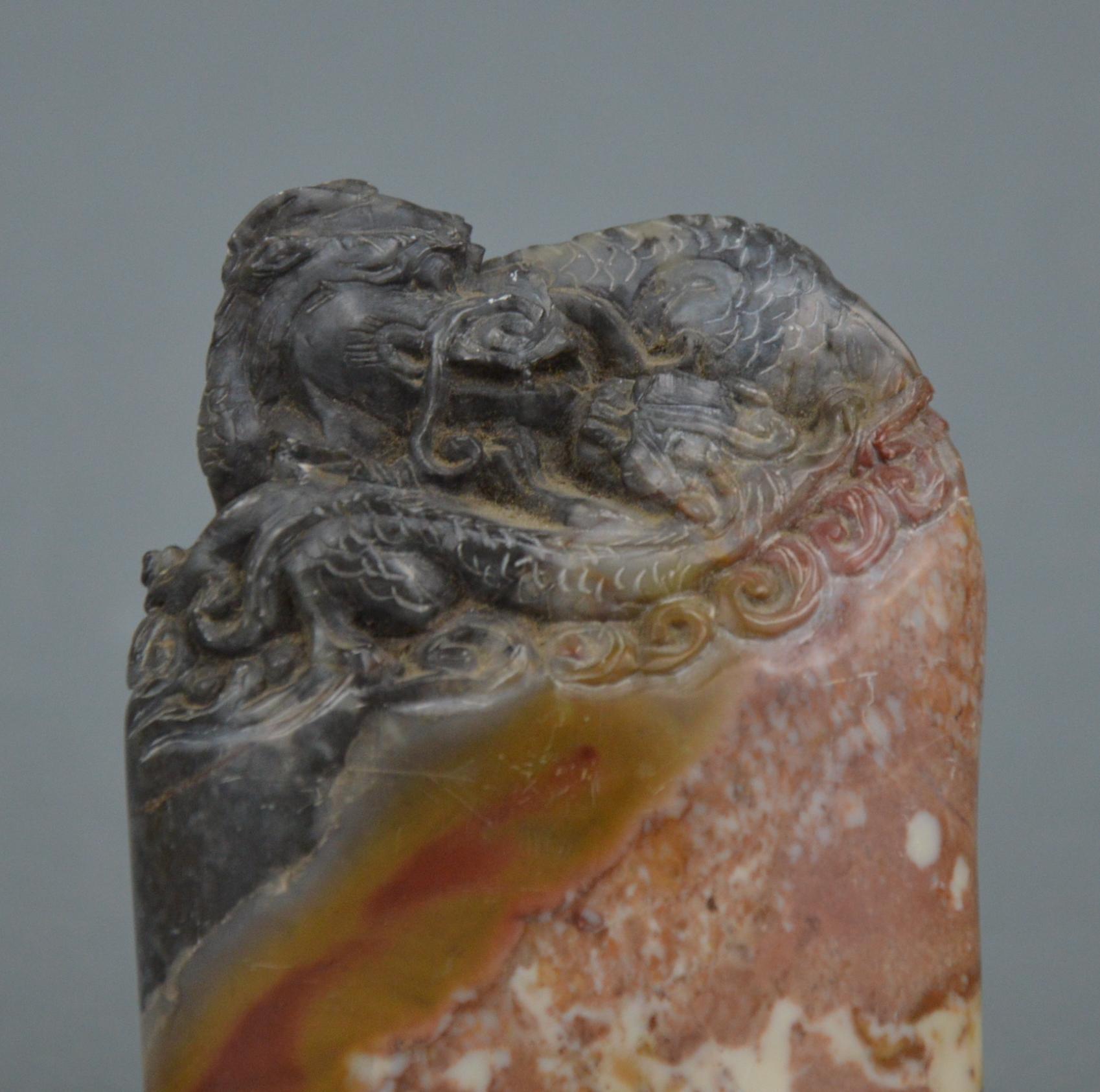 Miniature Chinese sculpture representing a dragon lying on a rock. Made of beautiful three-layered stone.
Dimensions: 8 x 6 x 2.5 cm.