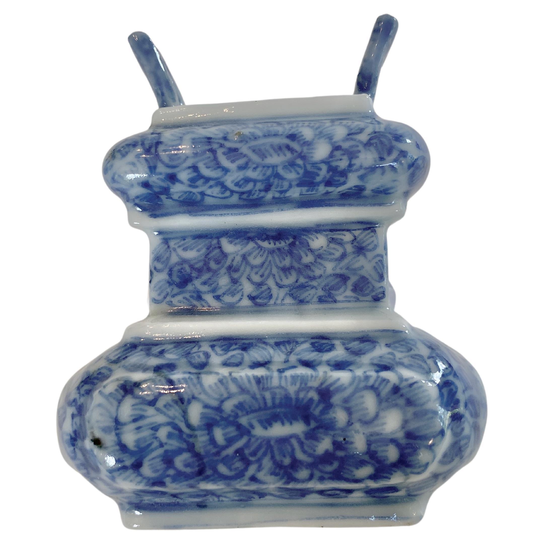 Miniature Chinese porcelain vessel in the form of an incense burner with handles, Qianlong period (1735-1796). It is decorated with one large flower, whose vivid blue petals cover the surface. There is restoration on one of the handles. The piece is