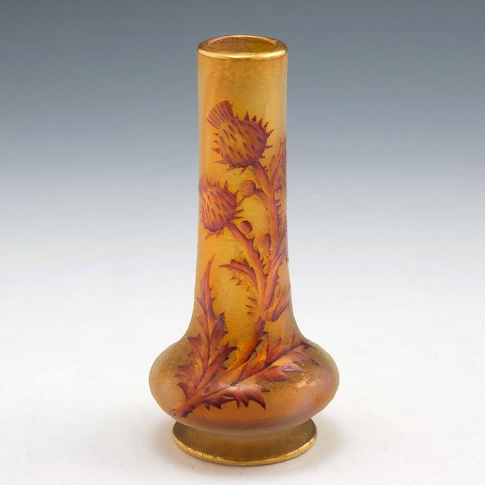Heading : A small Daum vase with
Date : 1890-1896
Origin : Nancy, France
Bowl Features : Striated iridescent acid etched ground. High relief enamelled thistles
Marks : Gilded mark on base Daum Nancy as shown
Type : Lead free glass
Size : height