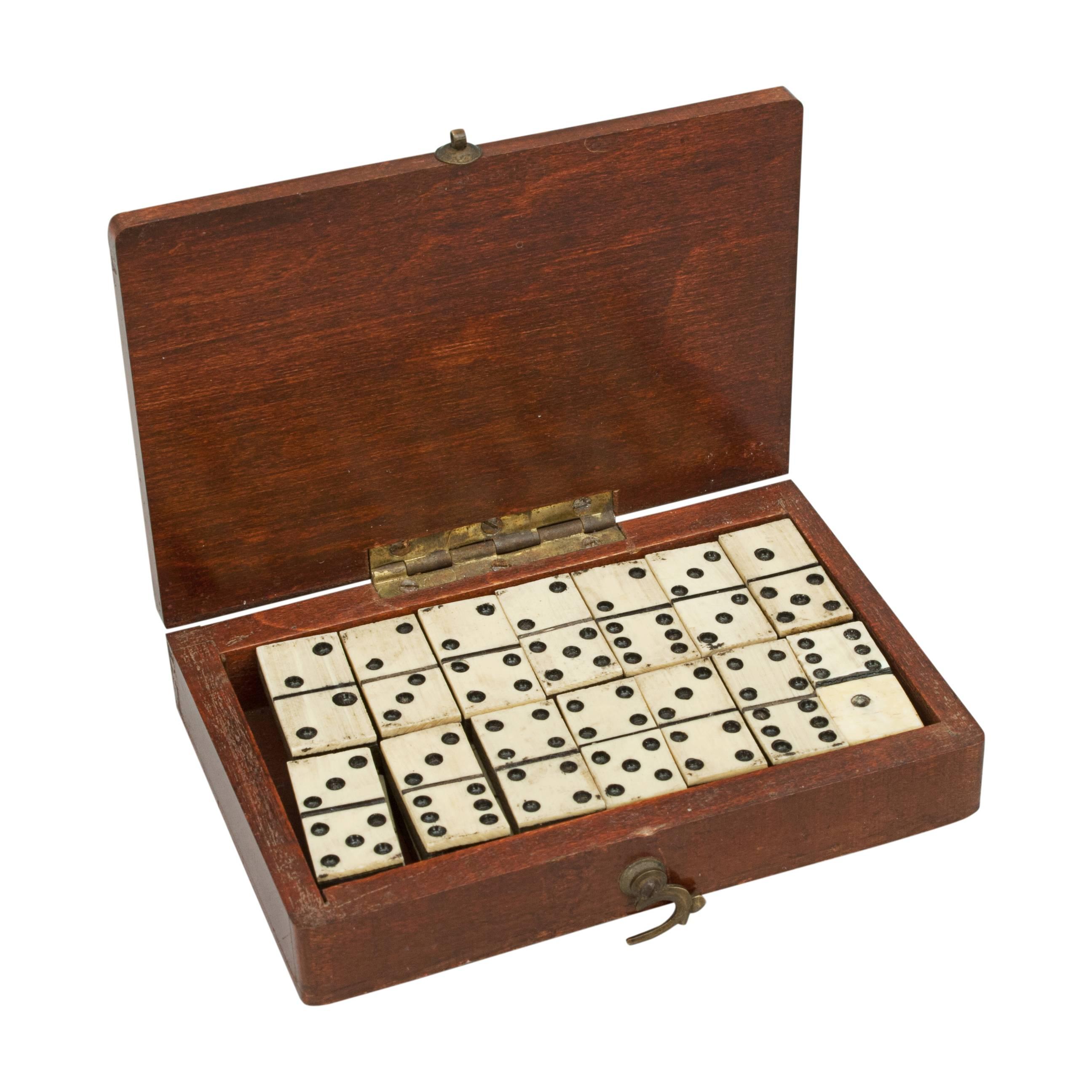 Miniature Domino set in mahogany box.
A set of pocket dominoes in a original mahogany box. Each domino is made of ebony and bone. There are 28 dominoes in total and each domino is sized: 2 cm wide, 1 cm deep, ½ cm high. A very unusual set of