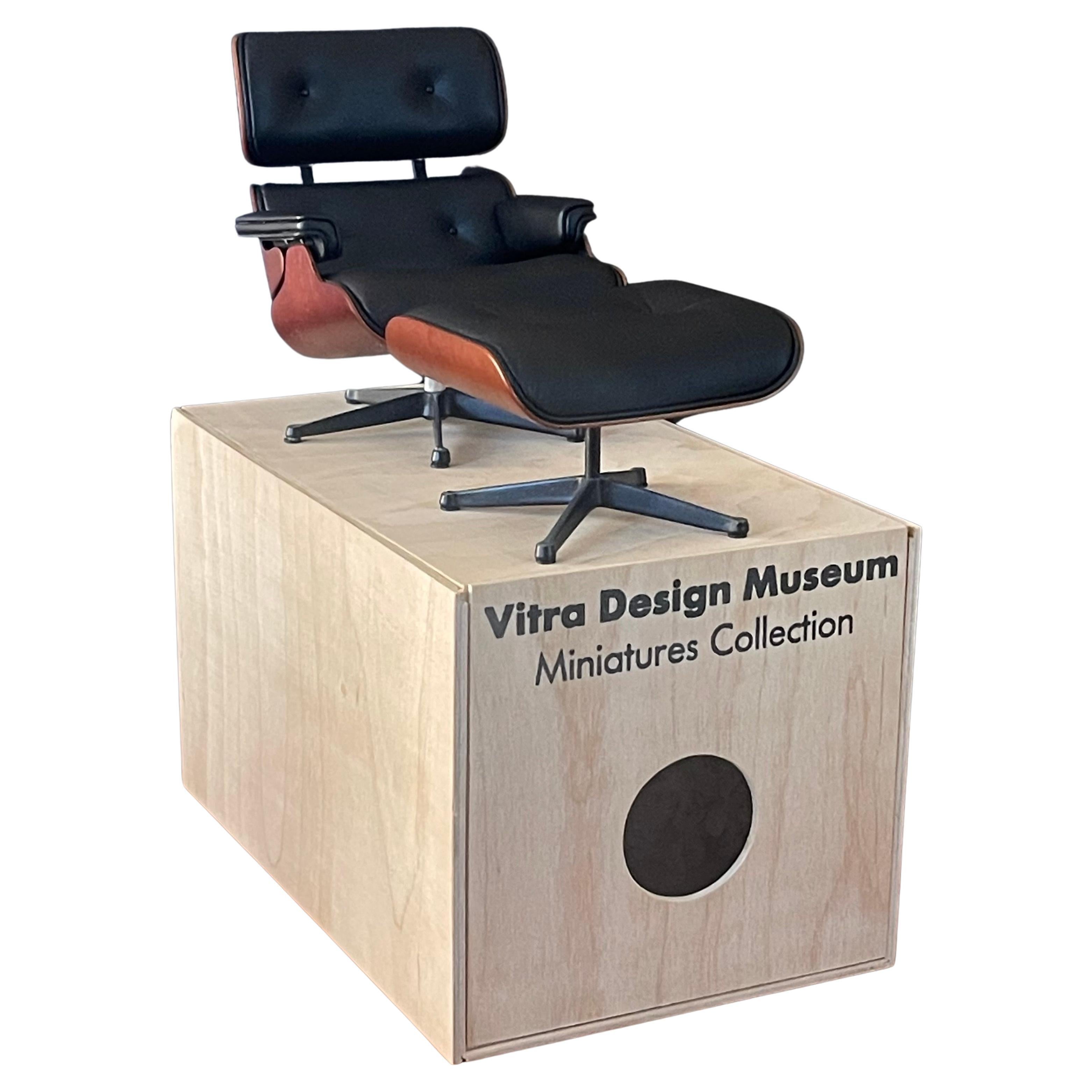 Miniature Eames lounge chair & ottoman with original box by Vitra, circa 2000s.  This super cool piece is in very good condition and measures 5.5