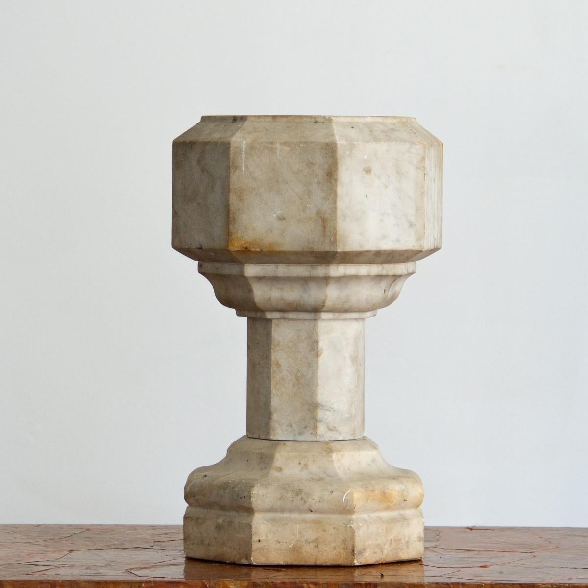 An English miniature baptismal, eight sided font in white mottled marble, circa 1860. 

In the 18th and 19th centuries, baptisms were ordered privately as status of High Society. These portable, miniature fonts would be commissioned and kept in