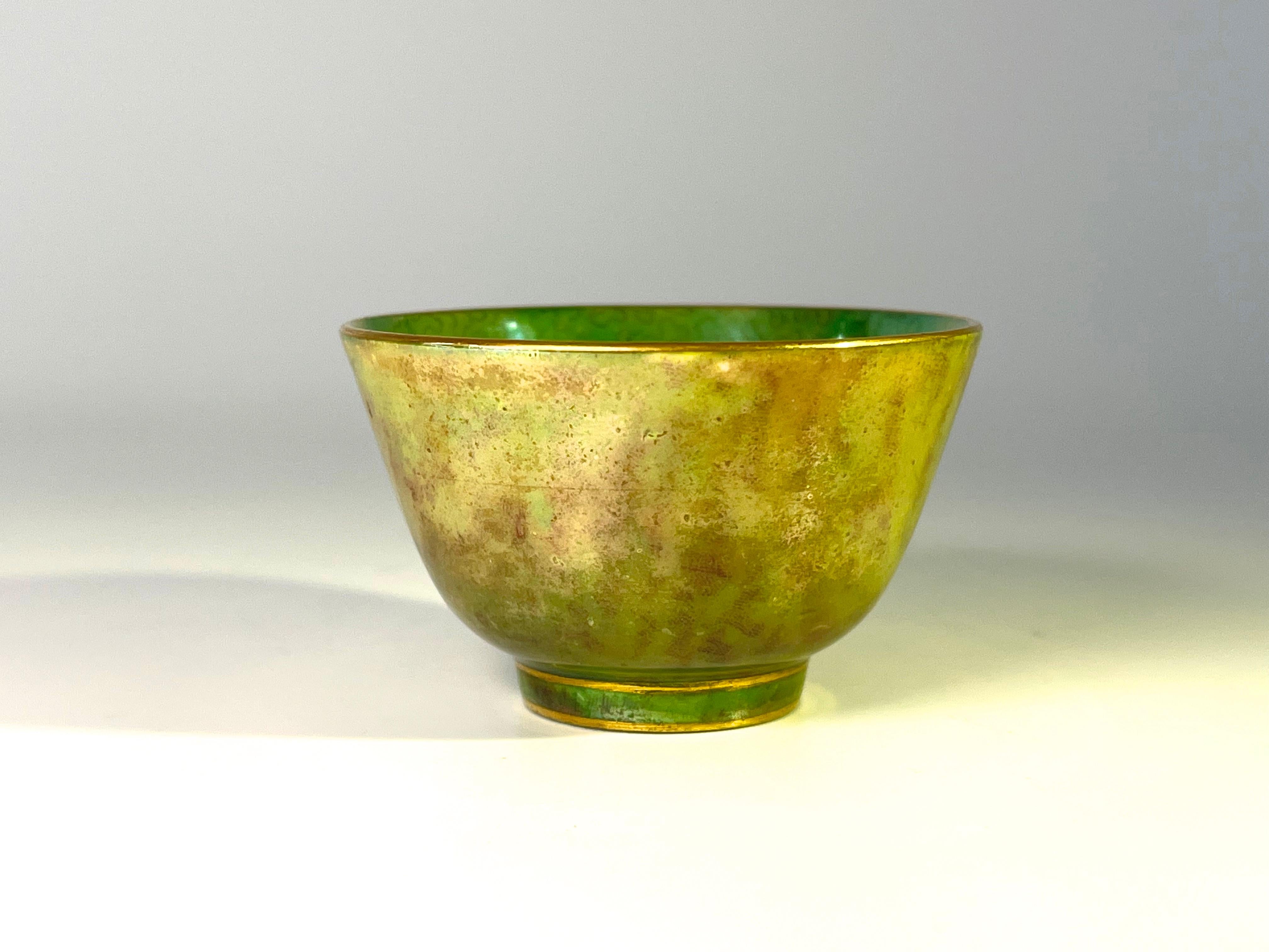 Absolutely delightful and delicate Daisy Makeig-Jones for Wedgwood, miniature bone china lustre tea bowl.
The interior is decorated with a mid green glaze, decorated with a muted labyrinth pattern. 
The outer is a wonderful rich chartreuse and