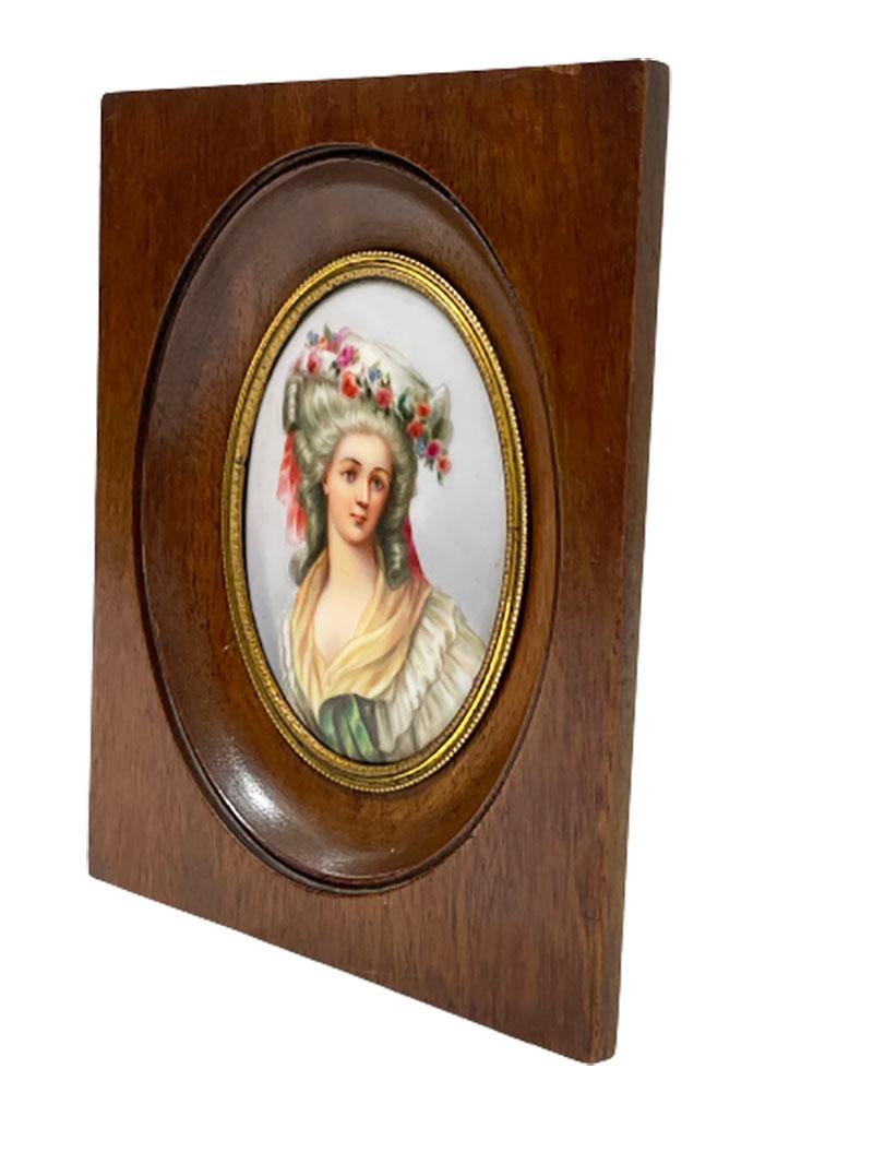 Miniature framed portrait of a lady painted on porcelain

An oak wooden frame with in oval placed porcelain plaque, painted with a scene of a lady wearing a hat with flowers.
French 19th Century

The measurements of the frame are 14,5 cm high,