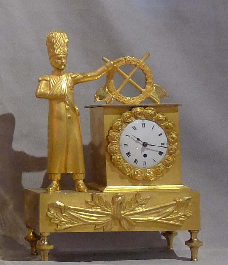 Fine miniature French Empire clock in ormolu. Dating from the First French Empire period with original ormolu and with fine enamel dial and movement signed The clock stands upon fine and delicate toupee feet. The the base is an applied ormolu mount
